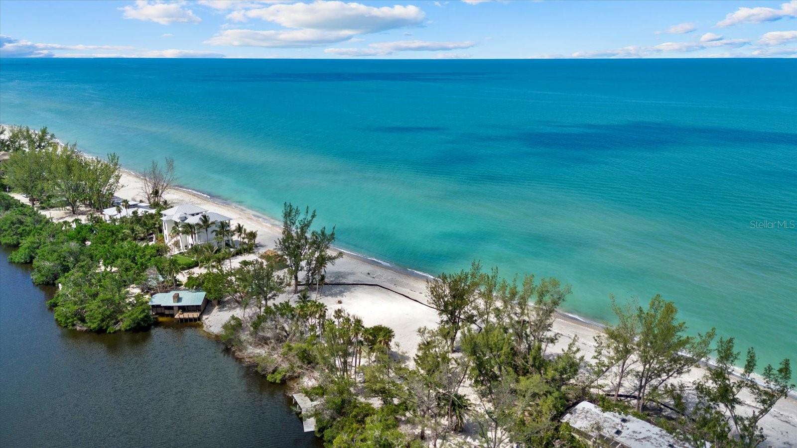 Discover an unparalleled opportunity to build your dream estate in one of Siesta Key’s most exclusive and private Gulf-front enclaves. Welcome to 8440 Sanderling Road—an extraordinary homesite located within the prestigious, guard-gated Sanderling Club. Spanning over an acre and offering approximately 275 feet of direct beachfront along the Gulf of Mexico, this rare property is a true slice of paradise. Positioned on a pristine stretch of tropical Siesta Key beach and backed by the tranquil waters of Heron Lagoon, the lot also includes a kayak launch for private water access to the lagoon. Its unique positioning offers both expansive Gulf views and the peaceful serenity of lagoon frontage, creating a setting that’s as rare as it is breathtaking. Sanderling Club residents enjoy unmatched privacy, tropical beauty, and access to exclusive community amenities including a bayside marina, tennis courts, and 24-hour security. As a volunteer site for the Mote Marine Turtle Preservation Program, the property also plays a quiet role in local conservation efforts. Whether you envision a modern architectural statement or a secluded coastal retreat, this Gulf-to-lagoon homesite provides the canvas for a one-of-a-kind legacy property on Siesta Key.