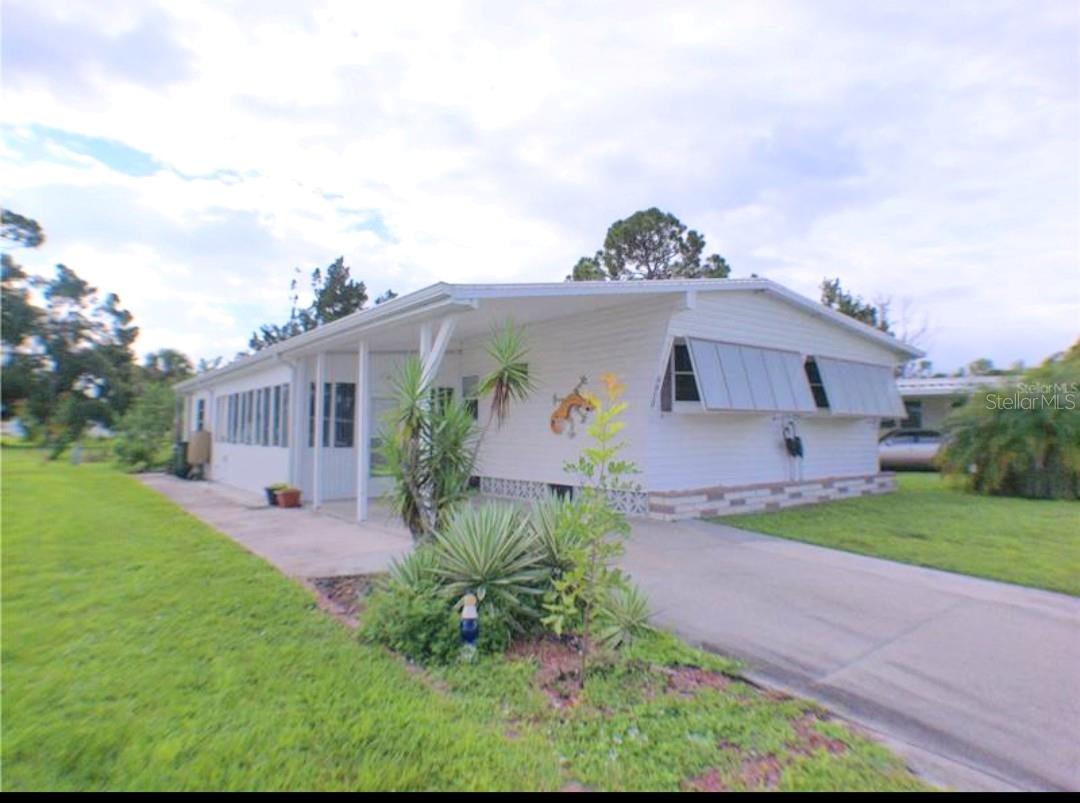 Double wide mobile home RARE to find with 3 bedroom & 2 bathrooms located in “HOLIDAY PARK!” 55+ maintenance free gated community! PRICED TO SELL! You won’t believe the feeling of space & comfort in this incredible home offering center island kitchen, living & family room, dining room with sliding doors leading out to the back yard area and 19 foot enclosed Florida room! All bedrooms have mirrored closet doors & ceiling fans! Home has lots of storage space with 16 foot utility room, work bench, washer dryer, wet sink, storage shelving & more! Covered carport included! Enjoy the Florida sunshine in your own private patio with flowering shrubs, palm trees & tropical plants all around the back yard. Perfect setting for barbecues & entertaining guests! Home backs up to a peaceful private wooded landscaped area! Holiday Park amenities are plenty! If you like swimming, tennis, bocce, it’s all right here! RV storage on site! Home is minutes to shopping, churches & just a 20 minute drive to the gulf beaches! Won’t last! Newer ROOF,AC,WATER HEATER> ELEC BOX REWIRED......PORTABLE AC IN ENCLOSED LANAI.