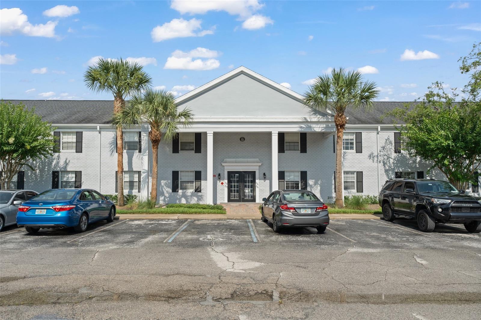 Welcome to this updated 2-bedroom, 2-bath first-floor condo in the heart of Winter Park. Tucked away at the back right corner of the building, this bright unit features an open living room with sliding glass doors leading to the community green space that is a tropical oasis. The adjacent dining area includes a stackable washer/dryer and flows into a modern kitchen with floor-to-ceiling cabinetry, granite countertops, and stainless steel appliances. Both spacious bedrooms sit near the entry, with the primary suite offering a walk-in closet and a sleek ensuite bath with a glass-front shower and floating vanity—mirrored in the guest bath as well. Enjoy low-maintenance living in a prime location! Schedule your private showing today!