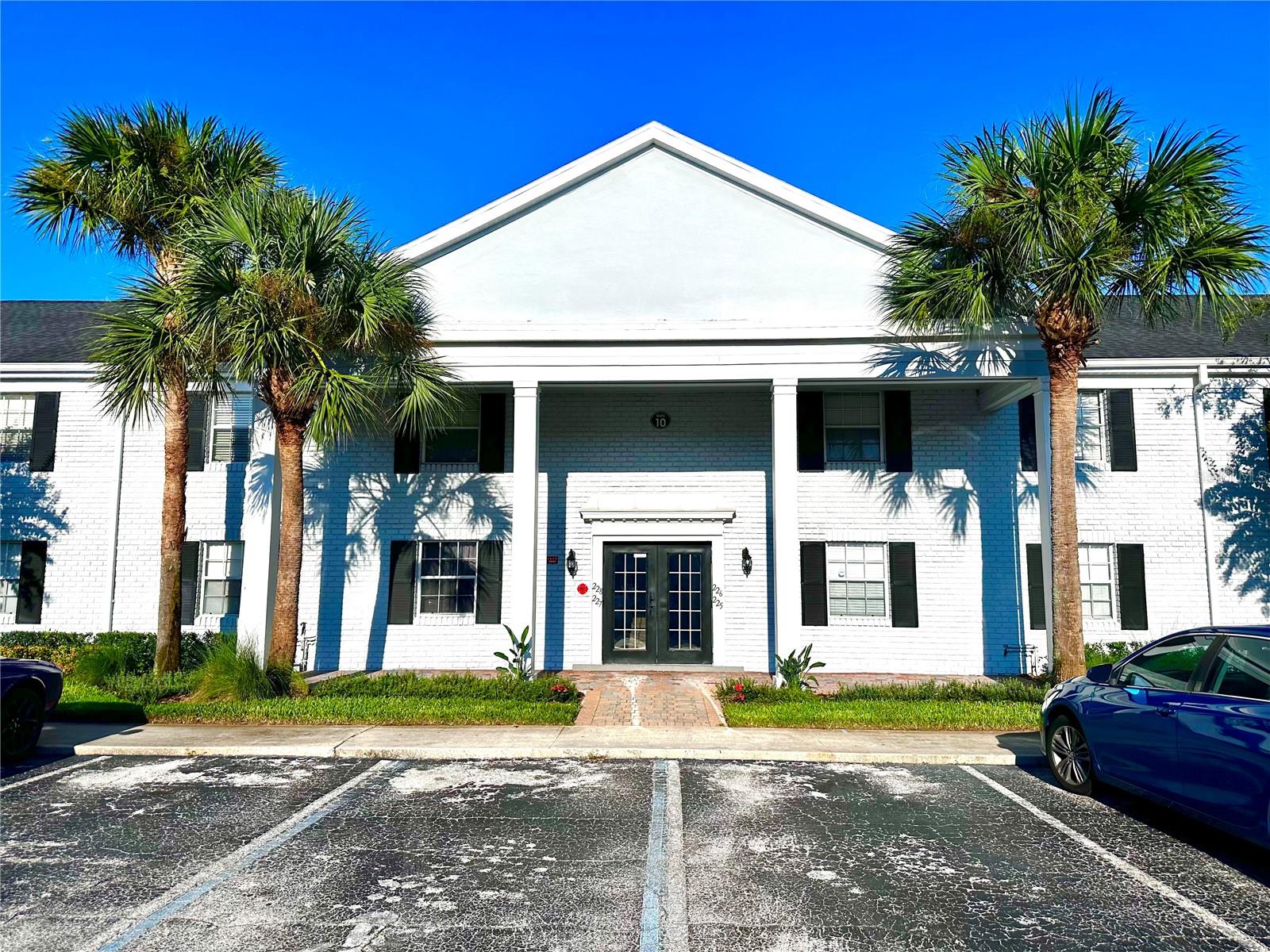 Welcome to this updated 2-bedroom, 2-bath first-floor condo in the heart of Winter Park. Tucked away at the back right corner of the building, this bright unit features an open living room with sliding glass doors leading to the community green space that is a tropical oasis. The adjacent dining area includes a stackable washer/dryer and flows into a modern kitchen with floor-to-ceiling cabinetry, granite countertops, and stainless steel appliances. Both spacious bedrooms sit near the entry, with the primary suite offering a walk-in closet and a sleek ensuite bath with a glass-front shower and floating vanity—mirrored in the guest bath as well. Enjoy low-maintenance living in a prime location! Schedule your private showing today!
