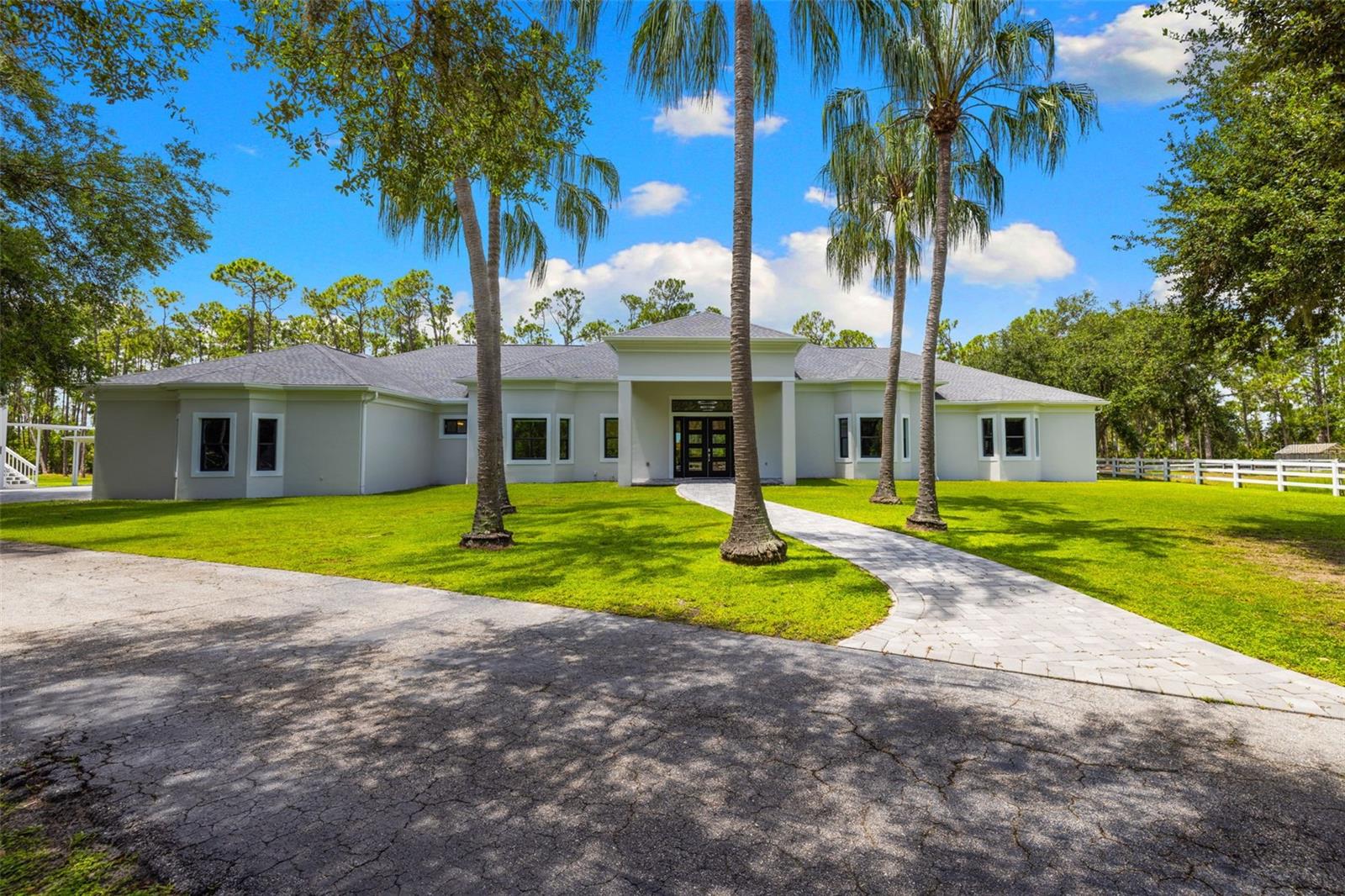 7051 Turtle Lane- a masterpiece of timeless luxury and privacy, nestled within the coveted gates of Sarasota’s prestigious Gator Creek Estates. Beyond the community gates, a second private gated entrance welcomes you home, leading you down a winding drive framed by a tranquil pond and fountain, creating an unforgettable sense of arrival.
Completely reimagined from the studs up, this estate showcases uncompromising craftsmanship and thoughtful design. Every detail has been renewed, from the new roof and electrical systems to the plumbing, all bathrooms, opulent light fixtures, and a complete kitchen renovation, as well as White French oak floors and bespoke California Closets throughout the home. The list goes on, but you must see it in person to fully appreciate the fine details! The chef’s kitchen is a showpiece, offering a gas cooktop, three ovens, three refrigerators, two dishwashers, a spacious walk-in butler’s pantry, crystal and blue quartz countertops, and abundant custom storage- an entertainer’s dream and a culinary haven alike. For ultimate peace of mind, the home is fortified with hurricane-impact windows and doors, and a built-in generator connected to a 500-gallon propane tank, ensuring comfort and security through any storm.
The primary residence offers four bedrooms, three of which are en-suite, with one thoughtfully repurposed as a private office or den, discreetly housing an approximately 9x7 integrated safe room. The primary suite is a private sanctuary, featuring dual spa-inspired his-and-her bathrooms adjoined by a walk-through shower, a sculptural soaking tub, and an impressive walk-in California Closet that you'll never want to leave. Within the primary wing, a sophisticated media room awaits, complete with a wet bar featuring a sink, dishwasher, and mini fridge, making it the perfect space for entertaining or a quiet retreat.
Beyond the main home, the estate offers five garage spaces, three of which are attached and two of which are detached. A one-bedroom, one-bath guest studio, elegantly positioned above the detached garage, is ready for your personal design. Outside, expansive covered lanais and a vast screened entertaining terrace overlook the cleared and well-maintained grounds, providing a breathtaking backdrop for watching neighborhood wildlife, sunsets, or simply enjoying the peace of your sanctuary. Just beyond the home is a charming greenhouse, ideal for cultivating orchids, tropical plants, or an organic garden; a peaceful, refined escape for the discerning horticulturist.
Notably, this estate is not located in a flood zone and has never been impacted by hurricanes, a rare combination of beauty and resilience that offers lasting peace of mind.
In today’s market, recreating a property of this caliber, on acreage of this scale, at this price, is simply unattainable.
If knowing that your dream home has been meticulously renovated to withstand the fiercest storms gives you peace of mind, along with uncompromising security, comfort, privacy, and the rare luxury of space to truly live, this estate is precisely what you’ve been searching for. Located in an A+ school district and just minutes from the world-renowned sands of Siesta Key and Sarasota’s premier dining, golf, and cultural destinations, 7051 Turtle Lane is more than just a home; it is a legacy estate, delivering an incomparable lifestyle.