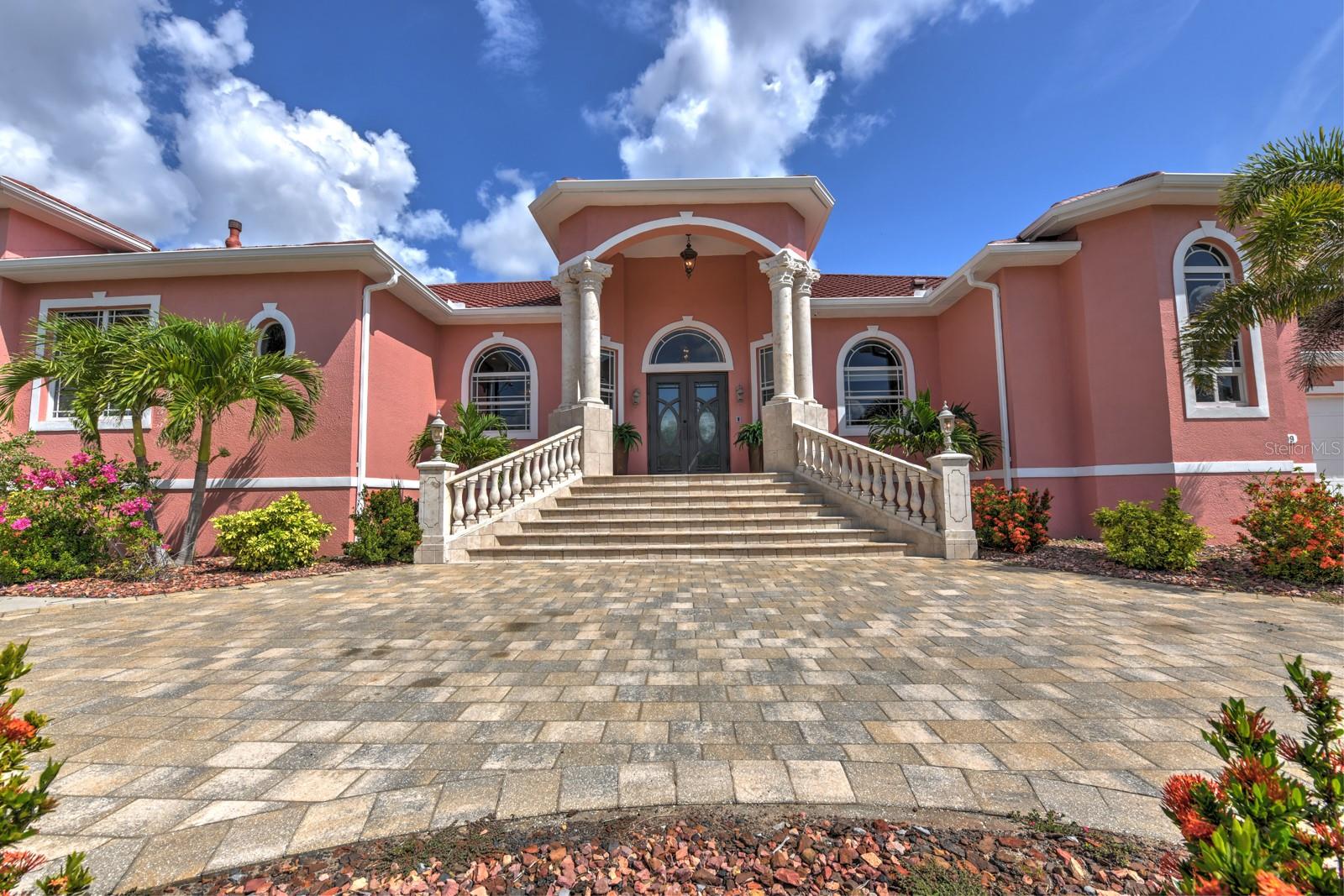 A BOATERS DREAM HOME!! 5 MINUTES TO OPEN WATER, 60 MINUTES TO THE I.C.W. and the GULF OF AMERICA! Despite it location on an excellent canal, THIS HOUSE HAS NO HISTORY OF FLOODING!! Breathtaking water views from your massive screened LANAI with 1961 square feet of saltwater POOL and outdoor space, and featuring a Gazebo-like custom outdoor kitchen and entertaining area. The HUGE DOCK sports 2 boat lifts, one covered, and 2 floating jet ski ports with water and electricity. Step inside this grand, custom-built residence to be greeted by a large GREAT ROOM with soaring 12 foot ceilings with an abundance of natural light and awesome water views. High-end finishes abound, from the exquisite tile and travertine flooring to the natural stone countertops. The CUSTOM KITCHEN is a chef's delight featuring all-new cabinetry and excellent WOLF appliances. The Master Bedroom and Bath are a beautiful private oasis sure to delight the most discriminating taste. There is a handsome private OFFICE, and a custom MEDIA ROOM with wet bar and surround sound theatre. The huge garage has space for 4 vehicles, or 2 vehicles plus toys or a workshop. The new 2023 METAL ROOF and the newer impact windows far exceed Florida's hurricane standards. Two newer HVAC systems (2021 and 2022), two tankless water heaters (2020 and 2023) and a 500-gallon underground propane tank ensure maximum comfort and dependability. Other improvements include a heated salt water pool, water softener and reverse osmosis water system, and large boat canopy. The excellent Charlotte Harbor Yacht Club is across the street with a marina, fuel, a nice restaurant and bar open to the public, and many fun activities for members. A few minutes away by CAR OR BOAT are outstanding restaurants and pubs, the wonderful Fisherman's Village, the incredible Sunseeker Resort, 3 marinas, public golf courses, and numerous festivals and musical activities. If you seek the ultimate in luxury, convenience, and the unparalleled MAGIC of coastal Southwest Florida, you have arrived!!