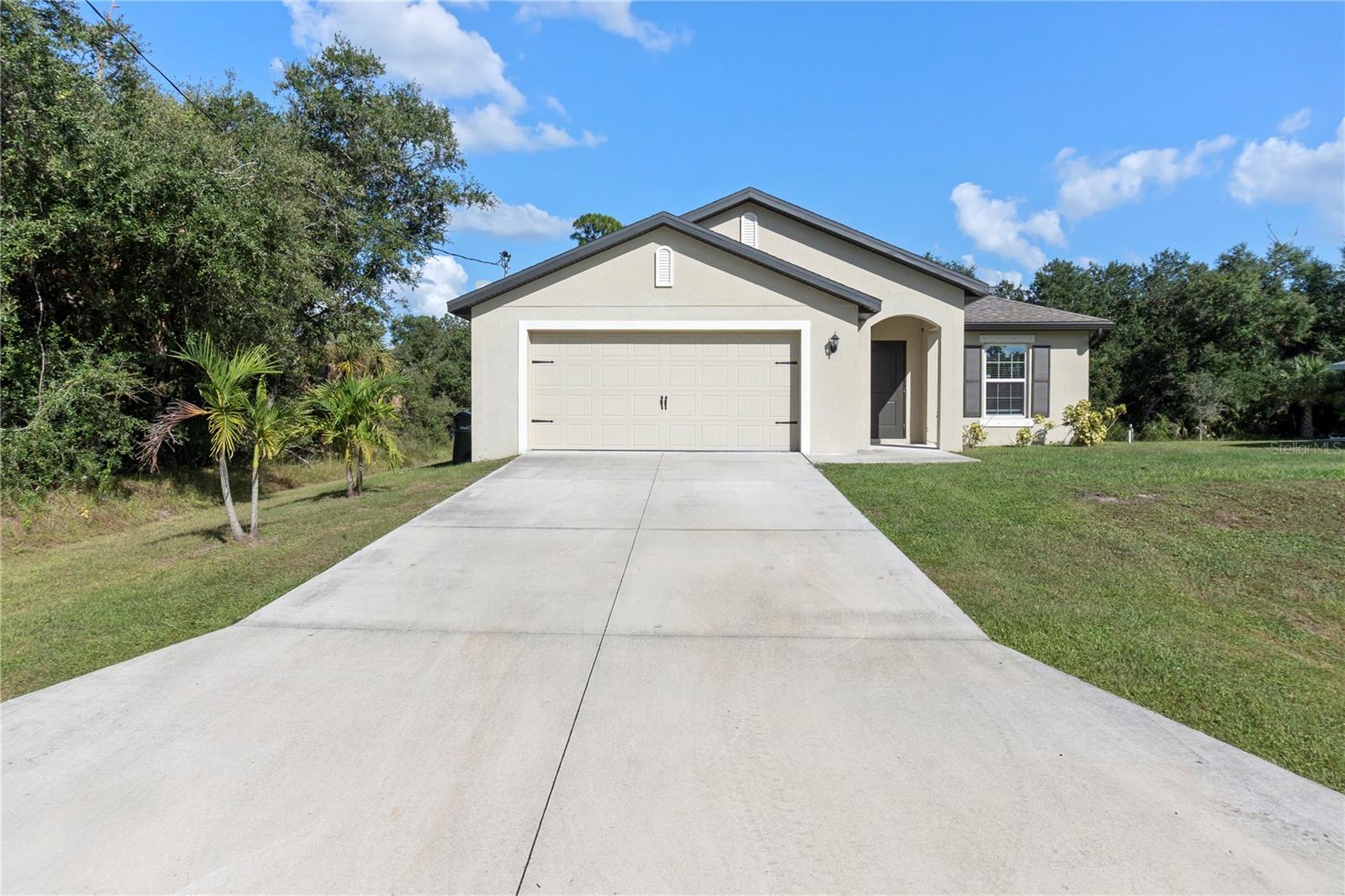 Welcome home to this cheerful, like-new property nestled in a fast-growing area of North Port! Built just three years ago, this home offers that “new home” peace of mind — with all the charm of a space that’s ready to make your own. As you step inside, you’ll love how light and bright it feels, with an open floor plan that offers plenty of space to relax, entertain, and live comfortably. The large kitchen is the true heart of the home — featuring granite countertops, stainless appliances, and a large island perfect for gathering, and tons of room to cook and create. All the bedrooms are generously sized, giving everyone their own space, while the primary suite features dual sinks and a modern bath design. The dedicated laundry room keeps things practical, while the covered lanai and large yard invite you to enjoy the Florida sunshine year-round. With peace of mind that comes from everything still feeling fresh and new, you’ll also love the privacy this property offers — surrounded by vacant land on the side and back. All this, plus an unbeatable location near Kings Hwy, I-75, Veterans Blvd, and US-41 for easy commuting and access to shopping, dining, and more.