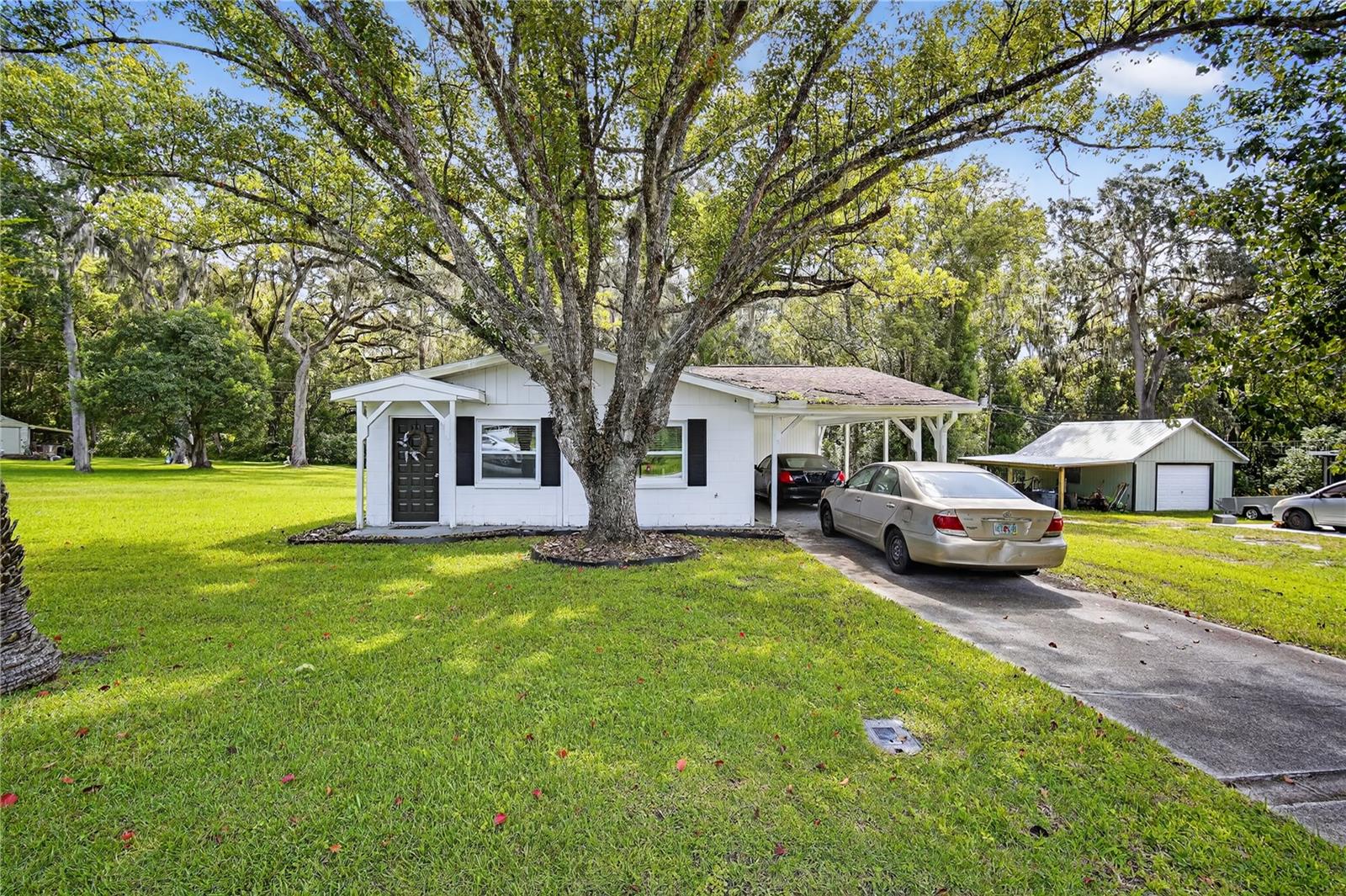 Move-in ready and fully renovated, this charming 2-bedroom, 1-bath block home in North Brooksville Heights offers peace of mind with a complete overhaul in 2022, including all new electrical wiring, plumbing, drywall, windows, luxury vinyl flooring, roof, and stainless-steel appliances. The updated kitchen features granite counters, solid wood cabinets, and modern finishes that flow seamlessly into the open living and dining areas, creating a light-filled and functional space. Both bedrooms are thoughtfully designed with ample closet space, while the bathroom showcases stylish upgrades. Enjoy morning coffee or evening relaxation on the covered rear porch overlooking the spacious yard with mature shade trees, perfect for gatherings or a quiet retreat. This property has undergone foundation remediation and comes with a transferable lifetime warranty and engineering report, ensuring the home is fully insurable and worry-free. Additional highlights include central A/C and heat, a carport with parking for two vehicles, new lighting, public utilities, and a convenient in-town location close to schools, shopping, dining, and medical facilities. Situated on a 0.21-acre lot with sidewalks and paved roads, this home qualifies for USDA financing—purchase with ZERO down payment! Whether you’re a first-time buyer or looking to downsize into something turn-key, this home delivers modern comfort, affordability, and reliability in a desirable Brooksville neighborhood.