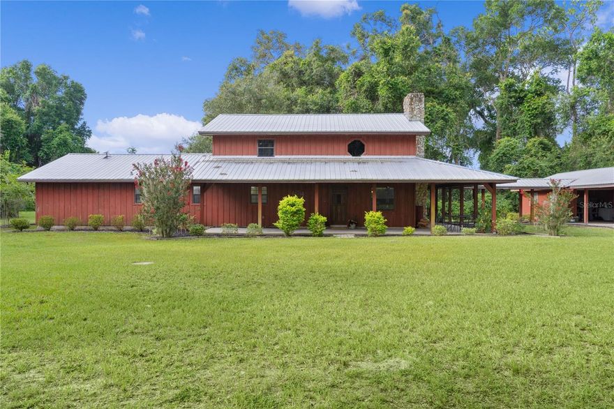 Privately set on 7.2 acres in Wildwood, this versatile property offers the space and flexibility ideal for trades, trucking, or personal business—just minutes from The Villages with direct access to I-75, Florida’s Turnpike, and Ocala. The custom-built home blends comfort and practicality with warm wood accents and a rock fireplace, while recent upgrades bring peace of mind: metal roof (2010), all-new plumbing (2021), updated electric (2023), new well pump (2024), full-house Generac generator with underground propane tank, and a solar-powered entry gate.
The layout includes a spacious primary suite with a walk-in closet, office, and built-in 36-gun safe—perfect for secure storage or workspace. A walk-in shower with grab bars adds everyday convenience. Outside, the property shines for anyone needing serious storage or working space. A brand-new 60x130 shop/pole barn offers endless possibilities—use for equipment, vehicles, or future build-out. You’ll also find a 33x40 pole barn, a 20x20 garage with workbench, A/C and lighting, plus an above-ground pool, concrete parking pad, and additional covered storage for tools or trailers. No HOA, no hassle—just usable land, smart upgrades, and room to grow your business or enjoy country living your way.