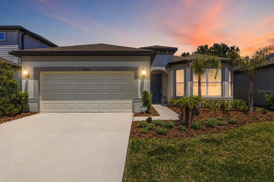 Built in 2024 and still showing like a model home, this stunning Valrico delivers the rare opportunity to step into nearly brand-new home with 2 primary suites without the wait. Every detail feels fresh, modern, and intentionally designed for the way you want to live today.

The open-concept layout seamlessly connects the living, dining, and kitchen spaces—creating an effortless flow for both everyday living and entertaining. The chef’s kitchen impresses with LVP flooring, stainless steel appliances, gas cooktop, wall oven, built-in microwave, quartz countertops, and a large center island with generous bar seating, making it the natural gathering point of the home. Throughout the main living areas, recessed lighting enhances the clean, modern aesthetic while providing a bright and welcoming atmosphere day or night. Whether it’s casual mornings or hosting friends, the space is built for connection.

The primary suite offers a private retreat with a zero-entry walk-in shower, dual vanities, and an expansive walk-in closet. A secondary bedroom also enjoys its own en suite bath, ideal for guests or multigenerational living. A dedicated office/den with French doors provides flexibility for remote work, creative space, or quiet study. An additional bedroom, full hall bath, and well-placed laundry room complete the interior layout with thoughtful functionality. Thoughtfully designed with a true split-bedroom layout, this home offers enhanced privacy throughout as none of the bedrooms share a common wall, thus creating quiet separation and a more peaceful living experience for both owners and guests.

Out back, a fenced yard and covered lanai extend your living space outdoors, offering a comfortable setting for relaxing evenings, weekend grilling, or simply enjoying Florida’s sunshine. With a tankless water heater and a truly like-new condition throughout, this home blends modern efficiency with elevated everyday living—ready for you to move in and start enjoying immediately.

Perfectly situated in Valrico, the home offers convenient access to everyday essentials, shopping, dining, while still maintaining a peaceful residential setting. Commuters will appreciate easy connectivity to major roadways for travel throughout the Tampa Bay area, including Brandon, Tampa, and surrounding communities. Parks, recreation, and local amenities are all just a short drive away, making this location as practical as it is desirable.
