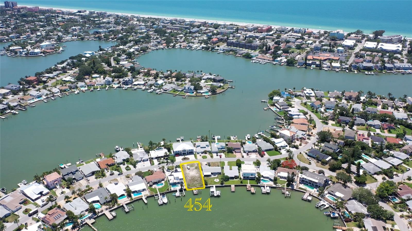 Your chance to acquire one of the most premier Intracoastal waterfront lots on one the most sought after streets on the island. This sprawling 7,196 sqft lot is waiting to be brought to life. The backyard faces Northeast allowing full enjoyment of the summer breezes and breathtaking sunrises. The oversized dock spans 11.5ft x 28ft and draws incredibly deep water for sailboats and deep draft crafts alike. Ideally located near waterfront restaurants and easy access to the Gulf of Mexico and spoiler islands. The seawall spans 55 linear feet and boasts a newer seawall cap and vinyl panels ensuring years of peace of mind. The survey and soil reports are complete and the lot is ready for your brand new home! Getting to the beach is a breeze with 24 local beach accesses, and both priority resident and golf cart parking. Positioned in the greater Tampa Bay Area near two international airports, world famous inshore and offshore fishing, championship caliber professional sports, and booming downtown St Pete. Welcome to Indian Rocks Beach, a coveted vacation destination driven by a loving and local community determined both to stay small and welcome all.