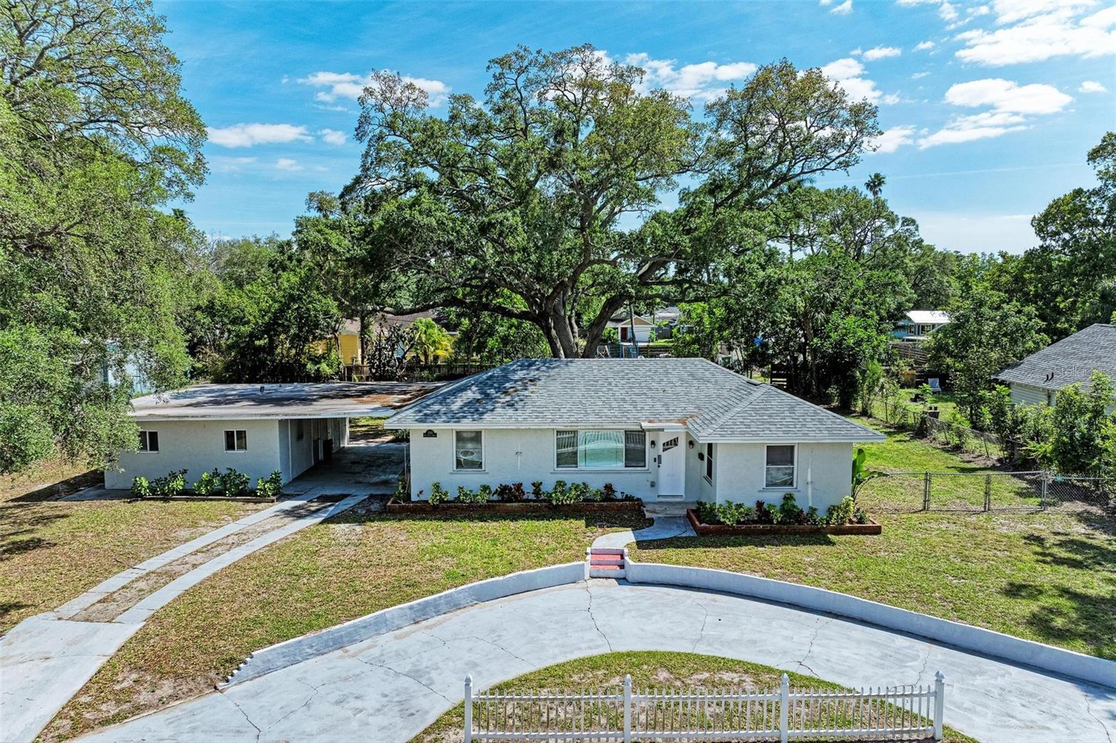 So much space in the heart of town! This remodeled 3 bedroom/2 bathroom home rests on two and a half lots just west of Wares Creek. A detached Auxillary Dwelling Unit with its own bathroom is the perfect space for your home-based business, your expanding hobbies or an aging parent. Bring your boat and RV because the backyard is very spacious with well-kept mature trees. The view from the primary bedrooom feels like resting in a park. Enjoy the outdoors from your covered patio or under the stars around a campfire. One mile from downtown Bradenton and an easy eight-mile drive to Manatee County Beach, your gateway to Anna Maria Island.