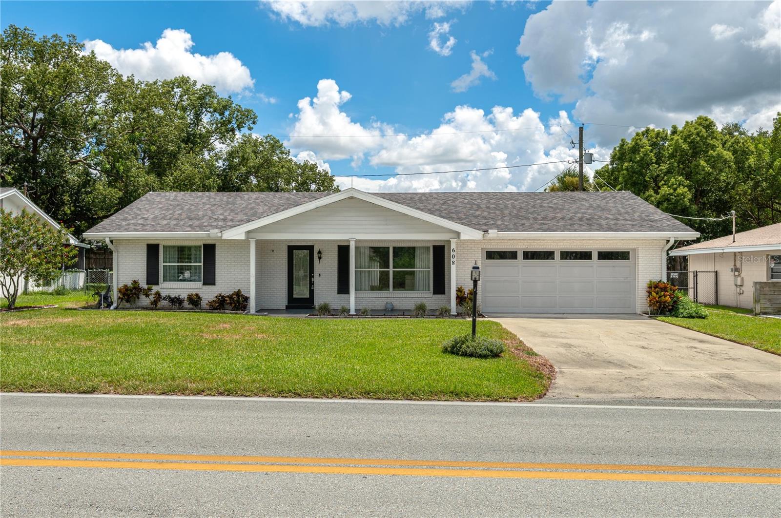 The beautifully updated home offers comfort, efficiency and curb appreal in a great neighborhood. Inside, you will find two spacious bedrooms along with two full baths. There is a large enclosed Florida room surrounded by all windows, perfect for year-round enjoyment. The roof was replaced in June 2021 and has a warranty. Solar panels were installed in 2022 and will be paid off at closing. The average electric bill is between $15.00-$25.00 a month. There is a Leaf Filter gutter system that was installed in November 2022. The backyard is completely fenced, ideal for pets, gardening or outdoor atherings. Nice landscaping enhances the property's inviting feel. Move-in ready and packed with features you'll love.