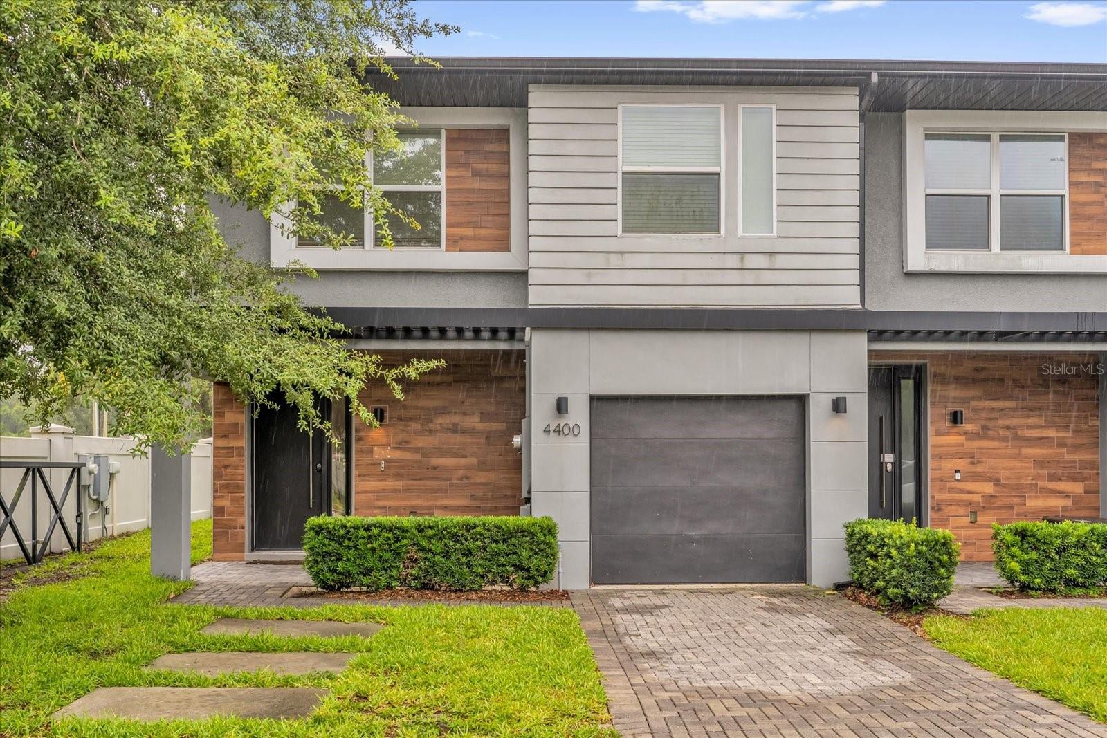 Experience stylish, turnkey living in the desirable gated community of Le Reve, in the heart of Kissimmee. This beautifully furnished corner townhome features four bedrooms and 3.5 baths, offering an open-concept layout with modern finishes, including Italian-style soft-close cabinets, quartz countertops and stainless steel appliances. Step outside through oversized sliding doors to enjoy your private screened patio, complete with a spa-sized pool and outdoor kitchen, ideal for relaxing or entertaining. Upstairs, two bedrooms feature en-suite baths, while a third full bath and laundry closet provide added convenience. Professionally decorated and move-in ready, just minutes from restaurants, shopping and only 15 minutes from Disney. With Super Walmart right across the street, everything you need is close by. Don't miss this opportunity to own a stunning home in one of Orlando's best-located communities, schedule your tour today!