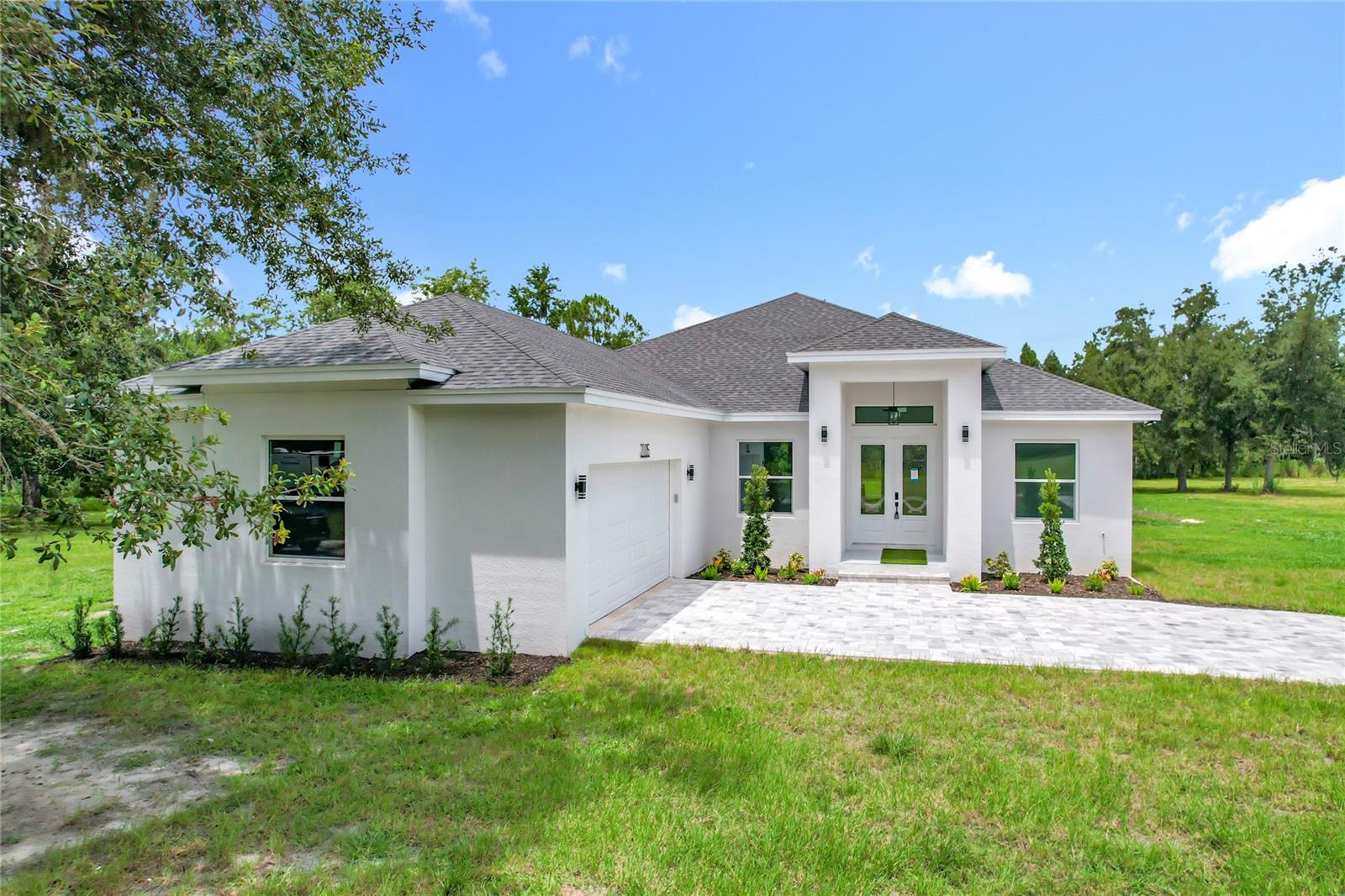 NO HOA – NO CDD – 2 ACRES – 2.5 MILES TO I-4 – 12 MILES TO TAMPA!
Bring your toys, RV, boat, camper, etc. —experience country living with all the benefits of the city nearby!
Discover this stunning new construction home nestled on a tranquil wooded homesite in Plant City. Offering the perfect balance of peace and convenience, this 3,617 sq. ft. contemporary residence features:
4 spacious bedrooms, 3 full bathrooms, Private home office, game room, 2-car garage.
Step into the welcoming foyer and enjoy the open-concept floor plan, soaring ceilings, and abundant natural light throughout. The heart of the home is a chef’s kitchen boasting gleaming quartz countertops, rich wood cabinetry, and walk-in pantry—perfect for both everyday living and entertaining. Unwind on the full-length back porch and take in the serene wooded views—a peaceful retreat just minutes from I-4 and a short drive to downtown Tampa.
A rare combination of space, style, and location—don’t miss this exceptional opportunity to enjoy luxury country living with no HOA or CDD!