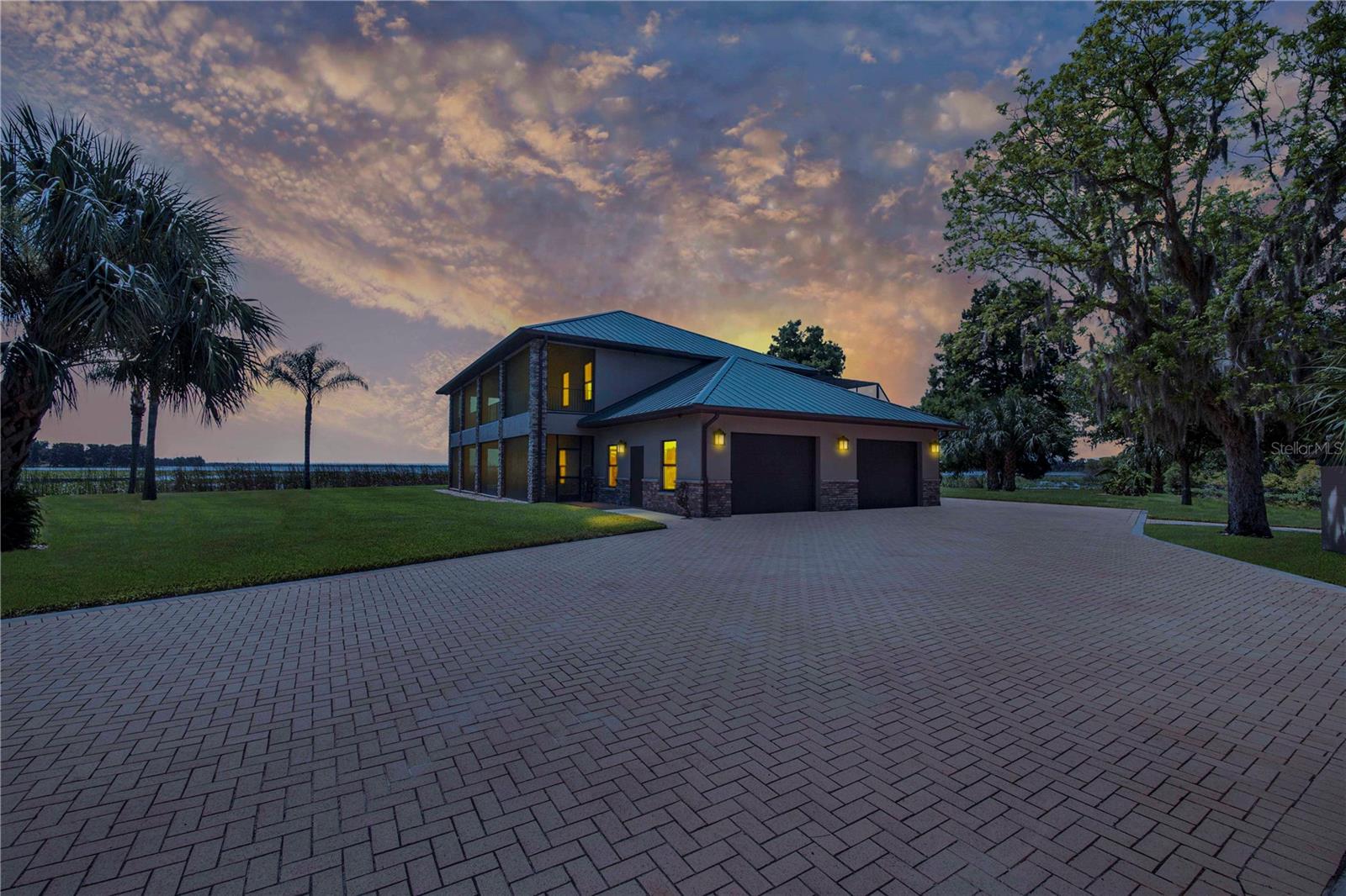 One-of-a-Kind Lakefront Oasis on Lake Pierce! This custom-built 3-bedroom, 2 full bath, 2 half bath pool home is truly one of a kind, offering unmatched views of Lake Pierce from every corner of the property. Featuring both upstairs and downstairs fully equipped living spaces—including kitchens, living rooms, bedrooms, dinettes, and laundry rooms—this home is ideal for multi-generational living or a private in-law suite. Access between levels is made easy with a built-in elevator. Enjoy resort-style living with a heated saltwater pool surrounded by beautiful lighting, a convenient half bath near the pool area, and a dedicated pool equipment storage room. Entertain effortlessly with a full Bluetooth-enabled sound system featuring six outdoor speakers, plus separate Bluetooth sound systems and speaker setups for both upstairs and downstairs living areas. The wraparound porches on both levels are finished in rich Pecky Cypress, offering the perfect place to relax and take in the scenery. This lakefront paradise also includes a private boat ramp, boathouse with lift, and a matching metal-roofed pole barn with four stalls and two 50-amp RV hookups. Decorative pavers tie the look together seamlessly. Additional features include a whole-house Generac generator powered by an in-ground 500-gallon propane tank, custom insulated Hunter Douglas blackout blinds, elegant travertine flooring throughout, and a spacious three-car garage with a separate storage area. Every inch of this property has been thoughtfully designed with comfort, luxury, and functionality in mind. With too many upgrades to list, this is a must-see in person. Schedule your private tour today! THIS HOME IS SOLD WITH 2 PARCELS .65 ACRES TOGETHER