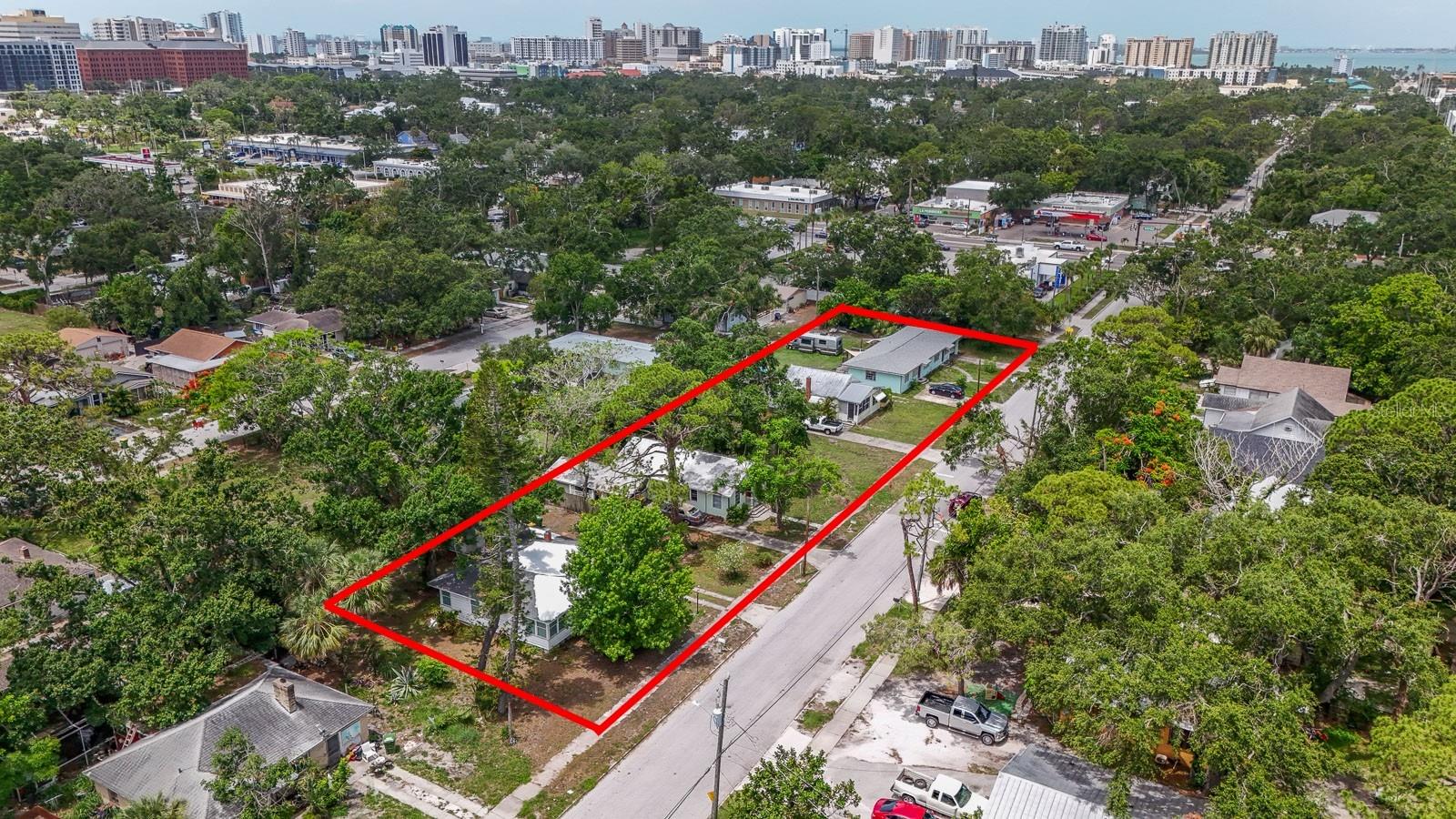 This centrally located, five-parcel assemblage in Sarasota’s Park East neighborhood offers a rare redevelopment opportunity in an area experiencing ongoing growth. Totaling approximately 35,000 square feet (350 road frontage x 100) deep or (0.80 acres), the site currently includes five income-producing rental units bringing in a total of $8,250 per month. The property is also situated within an Opportunity Zone. Zoning allows for mixed-use development with ground-floor commercial and multifamily residential uses as well as hotel developments with ground-floor commercial. The property supports a base density of 25 units per acre, with the potential to achieve up to 100 units per acre through participation in the City of Sarasota’s Attainable Housing Density Bonus Program. Building heights of up to four stories are permitted under current zoning. The property is strategically located near downtown Sarasota, US-301, Fruitville Road, and I-75, offering convenient access to local employers, retail corridors, and regional transportation. Nearby recreational and cultural amenities include Bayfront Park, Payne Park, Gillespie Park, and the Rosemary District. Rental income provides holding revenue while entitlements and development planning are pursued. Seller financing may be available, subject to terms. Buyer is responsible for verifying all zoning regulations, density bonuses, and development entitlements with the City of Sarasota.
