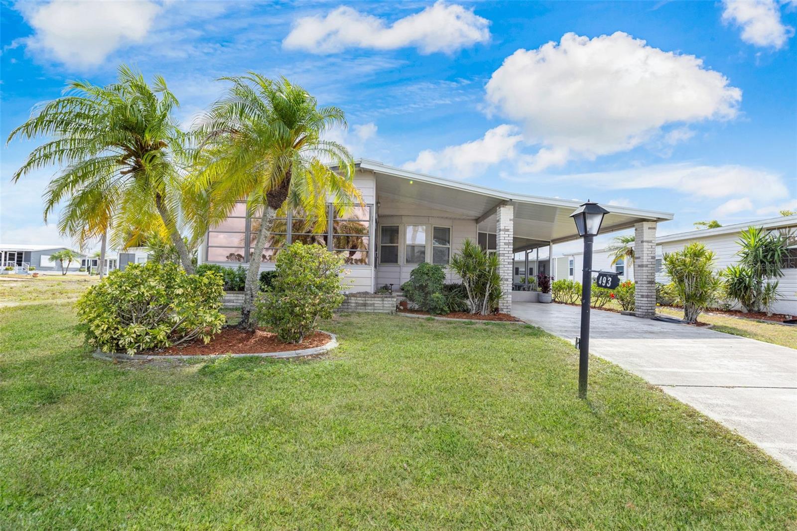 Discover the enchanting Florida dream lifestyle in this delightful home with a lake view, in a vibrant 55+ community known for its numerous amenities and gorgeous surroundings. This quality home faces a large lake and has a wonderful front porch to enjoy sunsets and large screened room to entertain, dine, or relax, in the shaded breeze. Inside, find an inviting open layout that seamlessly blends the spacious Living Room, Dining area and kitchen - perfect for hosting gatherings and creating lasting memories. The living room flows effortlessly into the Florida room/lanai providing an additional heated/cooled space for dining/relaxing and enjoying gorgeous sunsets over the lake. The generous master suite is large enough to easily accommodate the king bedroom set, with a walk-in closet, walk-in shower, and an abundance of bathroom cabinet storage. The guest bedroom, with queen bedroom set, is thoughtfully designed to ensure your visitors feel right at home. The nearby bathroom provides another large space with shower/tub and ample cabinet storage and counter space. There is an additional room which can be used as a small office, or walk-in pantry or as a future indoor laundry room. The shed, off the screened room, allows for laundry, ample storage, and is equipped with overhead storage and a well-stocked work bench area for gardening, crafts or other projects. This residence has been well cared for and equipped to ensure many more years of enjoying the Florida life with a durable metal roof, a brand-new A/C unit installed in 2023, double-pane windows with UV protection, newer appliances, and high-quality furnishings. This home promises both comfort and style. Embrace the ultimate Florida lifestyle - your dream awaits! Welcome to La Casa, an enchanting community where 974 exquisite homes are beautifully set among native trees, surrounded by spacious common areas and eight serene lakes. Our generous 60 by 80-foot lots offer your ideal space. Perfectly located between Sarasota and Fort Myers, La Casa is a boater's paradise with direct access to the stunning Gulf of Mexico. Enjoy easy access to shopping, sightseeing, golfing, and fishing, all while immersing yourself in the rich culture of Southwest Florida. Experience the warmth of Southwest Florida’s winters in a relaxed environment, far from the east coast hustle. Our lush, mature landscaping reflects the dedicated care of residents and management. La Casa features some of the finest pools in the area, including our magnificent 40 by 60-foot swimming pool, maintained at a delightful 87 degrees, and a cozy 20 by 40-foot pool nestled between the clubhouse and Activity Building, both with inviting hot tubs. Stay connected with our complimentary Wi-Fi at the Clubhouse, Activity Building, and Recreation Hall while you soak up the sun. La Casa is a family-friendly haven where you can enjoy tranquility while remaining close to vibrant attractions. Come visit our charming oasis and discover why La Casa is the ultimate destination for snowbirds and year-round residents!