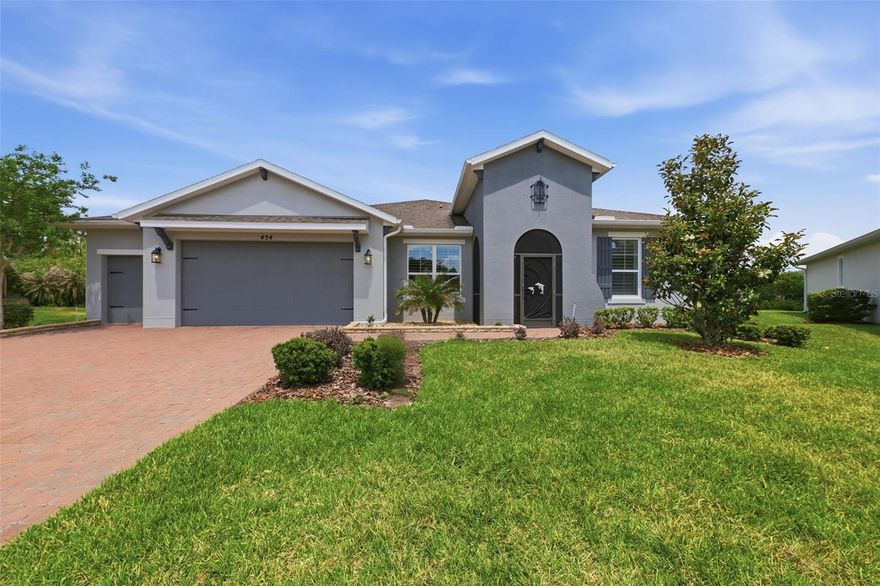 One or more photo(s) has been virtually staged. Welcome to Verona at Solivita, one of Central Florida’s premier 55+ resort-style communities, where lifestyle, comfort, and convenience come together beautifully. This impressive Serrano model offers 4 bedrooms, 3 bathrooms, a private office, and a 3-car garage, including a dedicated golf cart bay, all tucked away on a quiet cul-de-sac. When the home was built, the owner added a 2-foot rear extension, creating extra living space, an oversized dining area, and an expanded lanai that makes the home feel even more open and spacious.

From the moment you arrive, the home makes a statement with its all-glass front door, high ceilings, elegant finishes, and bright open layout. Inside, you’ll find tile flooring throughout the main living areas, carpet in the bedrooms, ceiling fans in every bedroom and office, and beautiful tray ceilings in the dining room. The home was freshly painted within the last 12 months and features expensive plantation shutters, with brand-new plantation shutters scheduled to be installed and included with the purchase.

The kitchen is designed to impress with a gourmet layout, stainless steel appliances, light color cabinetry, extended upper cabinets, and granite countertops that continue into the bathrooms. When built, the home was upgraded with a 2-foot rear extension, creating an oversized dining area and expanded living space that flows perfectly to the large covered lanai.

The extended enclosed lanai is one of the standout features of this home. Fully covered and screened, it offers an incredible outdoor living space and is already prepped for an outdoor kitchen, making it ideal for entertaining, relaxing, or enjoying Florida evenings in comfort.

Additional upgrades include a whole-house Pelican water purification system, irrigation included through the HOA, an 8-year-old roof, and thoughtful design features throughout.

Living in Solivita means enjoying one of Florida’s most active and amenity-rich 55+ communities. Monthly fees include cable, internet, lawn care, shrubs, and irrigation, giving homeowners a low-maintenance lifestyle. Residents enjoy access to clubhouses, multiple fitness centers, over 14 pools, dog park, baseball field, catch-and-release fishing, walking areas, social clubs, and even a drugstore located within the community. Golf is available separately, adding even more to the resort-style experience.

This is more than a home. It is a lifestyle. If you are looking for a spacious, beautifully maintained home in Verona at Solivita with premium upgrades, an oversized lanai, a 3-car garage, and access to world-class 55+ amenities, this one deserves to be at the top of your list.