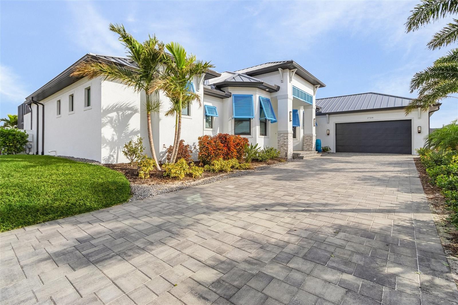 This 2023 custom-built masterpiece redefines luxury living, blending luxury design with exceptional functionality. Boasting over 3,000 square feet of meticulously crafted space, this home offers unparalleled features that cater to both comfort and style. Situated on a rare lot with direct Gulf access, the property is surrounded by water on two sides, providing breathtaking views and the ultimate waterfront lifestyle. As you step through the front door, you're immediately greeted by exquisite porcelain tile flooring that flows seamlessly throughout the open-concept living areas. The spacious living room, featuring an electric fireplace, is perfect for cozy nights in, while the two sets of 90-inch sliders open to the outdoors, enhancing the home’s connection with nature. The heart of the home is the chef’s kitchen, equipped with high-end appliances, including an induction cooktop, double oven, and a wine refrigerator. A large walk-in pantry provides ample storage, while the sleek countertops and custom cabinetry offer both beauty and practicality. The adjacent dining area is perfect for entertaining, with plenty of space for large gatherings. This home offers two luxurious master suites, each with their own spa-like bathrooms. The primary suite is a true retreat, featuring a walk-through shower with dual shower heads and an elegant dual vanity. The second suite is equally impressive, offering ample space and comfort for guests or family. Both suites boast large closets with custom built-ins for maximum organization. The non-conforming 3rd Bedroom is being used as an exercise room. The flexible floor plan also includes a dedicated office, perfect for remote work or a quiet retreat. Additional highlights include 2.5 baths with modern fixtures, a laundry room complete with cabinets and a sink, and a 2.5-car garage with an electric car charger and cable for added convenience. The whole home is equipped with a top-of-the-line alarm system and surround sound, ensuring both security and entertainment. The outdoor space is where this home truly shines. Step outside to your own private oasis featuring a custom-designed pool with vibrant light features and cascading waterfalls. The adjacent hot tub with a vanishing edge offers the perfect place to relax while taking in the stunning water views. This rare find offers direct Gulf access with unparalleled views and outdoor living, all within a thoughtfully designed custom home that seamlessly blends luxury, comfort, and cutting-edge technology. With its exceptional features and unique location, this home is truly one of a kind.