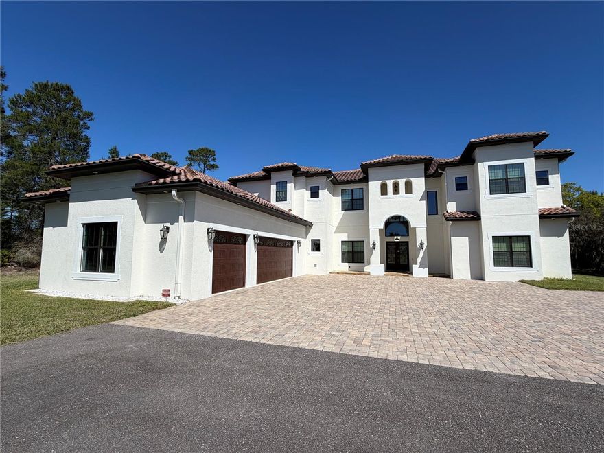 ONE OF A KIND! MUST SEE!

Experience timeless elegance combined with the tranquil ambiance of over 5 acres, just minutes away from Lake Nona! It is extremely rare to find the luxury of an AC-zoned lot that allows for farming, horses, cattle, and more, while still being within the vicinity of the city. This custom-built home epitomizes excellence with approximately 7,000 sq ft of living space and an oversized 3-car garage.

As soon as you walk in, you will feel the 20+ ft high ceilings and see the dual pocket slider glass doors that allow ample light to brighten your day. The thoughtful floor plan includes 6 ensuite bedrooms for ultimate privacy, an office/study room, and a playroom. The dual master bedrooms feature a covered lanai and a covered balcony with a view overlooking the enormous backyard.

Regarding the meticulous build quality, the home includes Carrier variable speed HVAC with humidity control, Icynene attic insulation, concrete barrel tile roofing, MI windows, PGT doors, and oversized 2 by 6 framing upstairs to fit more insulation. This brings your electric bill down to that of a home half its size. The oversized chef’s kitchen boasts luxury Wolf appliances, including a commercial-style 48-inch gas range top with a dual motor hood and a pot filler faucet, as well as natural stone to match the high-caliber build quality.

Other unique upgrades include a wet bar, a server room with Hudson security monitoring and recording, a mechanical room for easy HVAC servicing, an upstairs laundry chute, and ample hidden storage throughout the home. The patio features multiple areas on sealed travertine for versatile use and a custom outdoor kitchen. A guest bathroom is conveniently placed by the patio for future pool expansion. Pool drawings are available!

This home has the fundamentals taken care of, and the customization possibilities for final touches are endless with this lot size. This home is a must-see masterpiece that is priced to sell. Schedule your showing today!