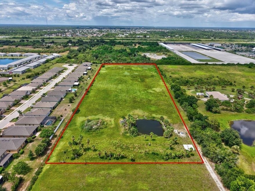 Currently zoned RE-1 but retaining its original grandfathered AE zoning, this property offers rare flexibility for agricultural, equestrian, livestock, and commercial agricultural ventures in Southwest Florida. Located just minutes from Port Charlotte, I-75, and US-41, it provides both the privacy of country living and the convenience of quick access to major routes, shopping, dining, and Gulf Coast beaches. This tract includes approximately 7.3 acres (330 x 950) with owner financing available and is one of seven parcels offered—totaling up to 45 acres if purchased together. Formerly a thriving tree farm, the land is ideal for crops, pasture, horses, or cattle, with sandy-loam soil, a full irrigation and fertilization system, and a well that provide abundant water for hay, fodder, and specialty crops. The property’s location and infrastructure also make it perfect for a Florida nursery property, landscaping business, or small farm operation, and it would make an outstanding private home site for those looking to move to Southwest Florida. Fully fenced for livestock, it offers a live/work property opportunity with a 7,200 sq. ft. main building available at an additional cost—details upon request—featuring 1,800 sq. ft. of air-conditioned space split between a hobby shop with full bath and an office with three rooms and a half bath. The 5,400 sq. ft. workshop/garage has seven overhead doors, a 5,000-lb-rated concrete floor, and a full bath, plus five covered vehicle ports that can be converted to stables, storage, or other uses. The main irrigation system, with a new 5-HP submersible pump on a 4" well, currently services 22 acres but is designed for the entire property, supplemented by an additional 4" well and a 2" well. With no wetlands or stormwater set-asides, every acre is usable, and existing oak and palm trees can be retained, relocated, or cleared. A nearby vacant lot on Harborview Rd. is also available for signage or an office location. Whether you are searching for Port Charlotte acreage for sale, Florida horse property with wells and irrigation, or the perfect Florida acreage home site with quick access to I-75 and US-41, this unique offering delivers location, infrastructure, and agricultural potential in one of the most desirable areas of the state.