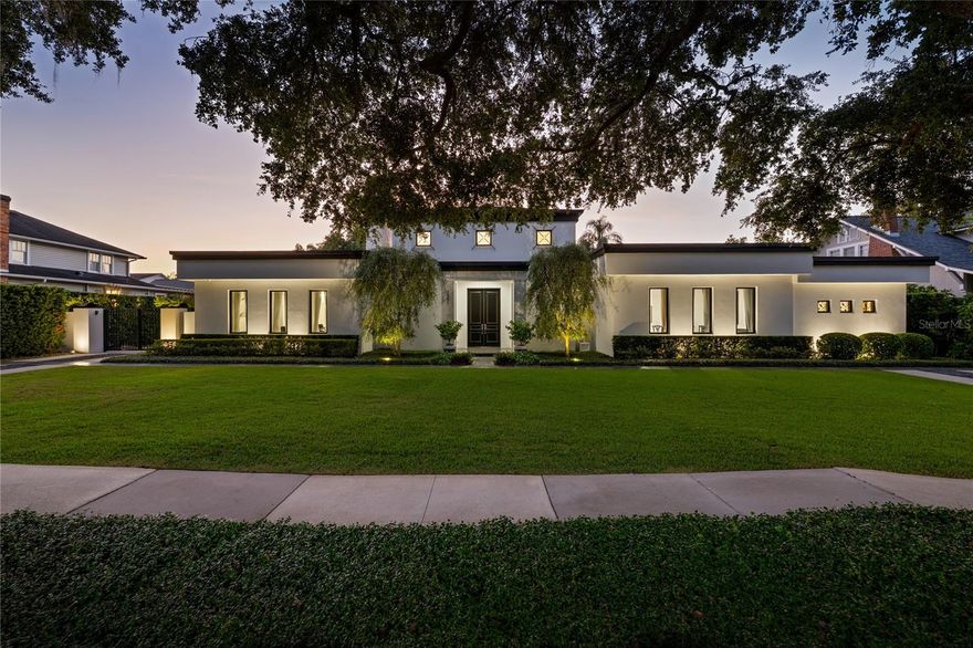 Just steps from the charm and energy of Park Avenue, this exceptional Winter Park residence was completely rebuilt in 2018 by renowned custom builder Posada Homes, member of the elite Master Custom Builders Council. Offering a rare blend of modern design, crisp architectural lines, and timeless elegance, on an expansive 0.39-acre lot along one of Winter Park's most picturesque tree-lined streets. The home immediately captivates with its refined architecture and beautifully manicured grounds. Inside, sunlight streams through expansive windows, illuminating hardwood flooring, intricate millwork, and thoughtfully curated finishes that reflect the craftsmanship of a true custom build. Just off the foyer, a hidden wine room provides a sophisticated surprise, perfect for those who love to entertain. At the center of the home is the chef's kitchen designed for both beauty and functionality. Outfitted with premium Thermador appliances, sleek quartz countertops, a generous center island, and custom cabinetry, the kitchen flows effortlessly into the expansive great room where high ceilings, designer lighting, and elegant architectural details create an atmosphere that is both inviting and refined. Tucked away for privacy, the primary suite is positioned just off a luxurious family room featuring custom built-ins and a gas fireplace. The primary suite itself is a true sanctuary, complete with a sitting area, private coffee bar, and a spa-inspired bath featuring dual vanities, a soaking tub, and an oversized walk-in shower. Rarely found in Winter Park, all bedrooms are conveniently located on one level, including two primary suites. The home offers seamless livability without sacrificing architectural interest or sophistication. Upstairs, a private office, half bath, and bonus room provide the perfect space for work, media, recreation, or relaxation. Outdoors, the home transforms into a private resort-style retreat. A covered lanai overlooks the sparkling pool and expansive grounds, creating the ideal setting for entertaining or quiet evenings at home. Adding even more flexibility, a 252-square-foot detached studio currently functions as a gym but could easily become a summer kitchen cabana, guest retreat, or art studio. Located within walking distance of Park Avenue's boutiques, restaurants, and cafés, and just moments from Rollins College and the Winter Park Chain of Lakes, this residence embodies luxury living at its finest. Don't miss this rare opportunity to own one of Winter Park's most outstanding homes. The current flooring offers a rich look, and for those who prefer a lighter palette, the seller is open to providing a credit toward flooring updates and coordinate the installation of new flooring if desired.