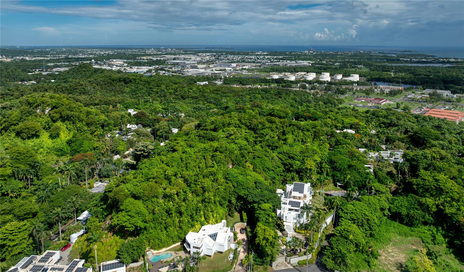 Perched at the summit of the prestigious Tintillo Hills neighborhood, this exceptional 2.57-acre parcel offers a rare opportunity to own the largest vacant lot in the community, a prime canvas for your dream estate. The land boasts unobstructed panoramic views of both the city and the surrounding mountains, creating a breathtaking backdrop that shifts with the light and time of day. This elevated vantage point not only ensures remarkable scenery but also offers a level of privacy and tranquility. Tintillo Hills is known as one of Guaynabo’s most exclusive, double-gated enclaves, home to a small collection of high end residences nestled among lush greenery. The neighborhood’s reputation for security, privacy, and prestige makes it one of the most sought-after addresses in the metropolitan area. Despite its secluded feel, the property is located just minutes from top-tier shopping, dining, and amenities. Residents enjoy convenient access to San Patricio Plaza, Suchville Plaza, and other premier retail destinations, as well as proximity to excellent restaurants and schools. The vibrant energy of San Juan is also only a short drive away, making this location the perfect blend of urban convenience and secluded luxury. * Images 2 and 4 are outlined approximations of the property.
