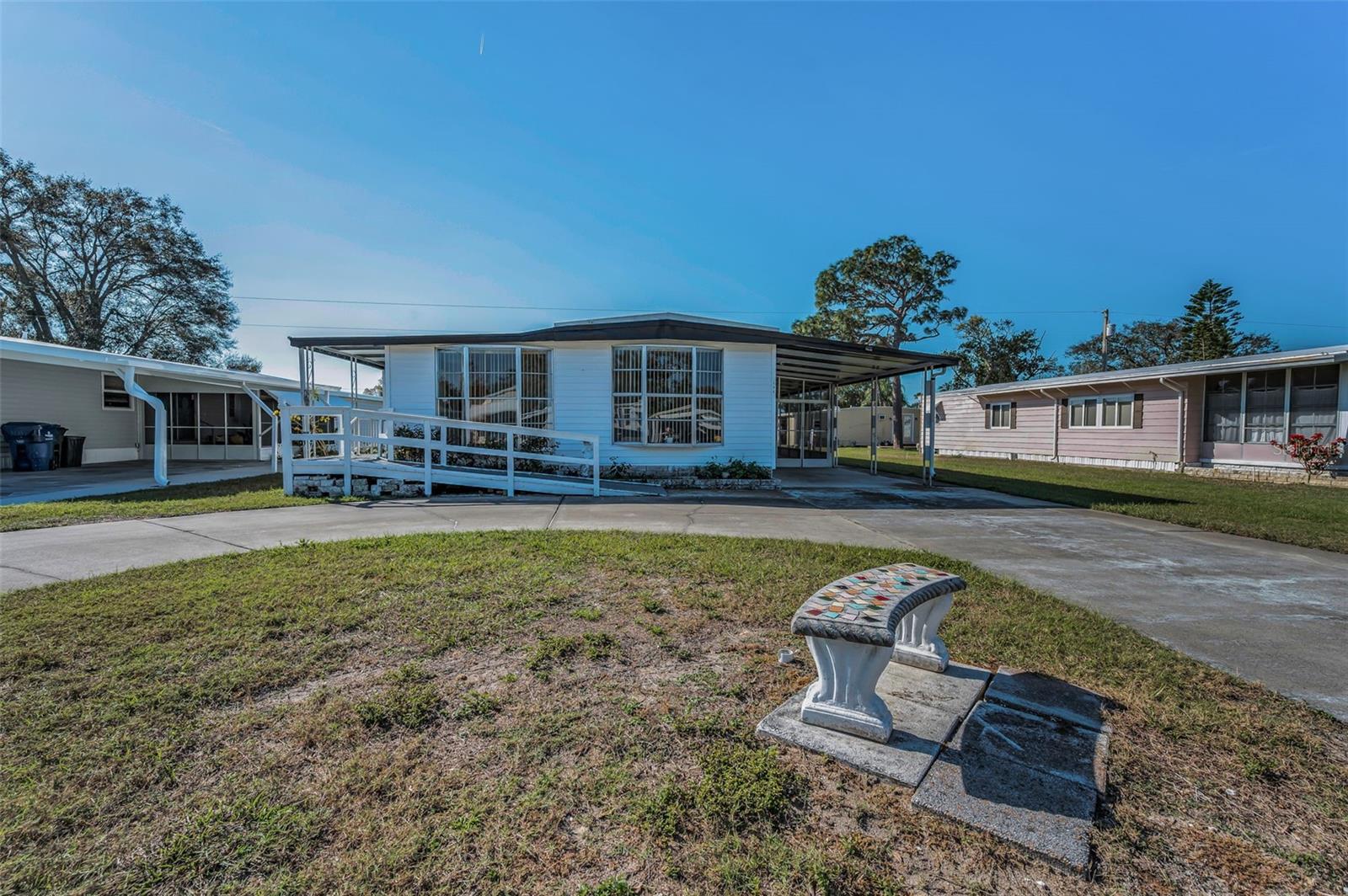 Welcome to Village of Lake Tarpon, a land-owned, golf-cart friendly, 55+ age retirement community in Palm Harbor! Situated along Lake Tarpon, enjoy the fishing pier, boating, and more. Priced to sell, this spacious mobile home has over 1,300 sqft. of living space to call your own. Featuring a split bedroom floorplan with 2 bedrooms, 2 bathrooms and a bonus room in the hallway that can be used as an office or what ever your heart desires. The 2nd bedroom has a built-in closet and ceiling fan. Adjacent to the 2nd bedroom is a full bathroom in the hallway with a new sink and faucet. The kitchen is central to the home and has ample room for a breakfast table and has an open window to the family room. The front living area of the home spans approximately 23 feet in length and offers flexibility to be used as both a living and dining space or as one expansive living room—whichever suits your needs! Beyond the front living area is a family room, full bathroom and a spacious primary bedroom with a built-in closet. Village of Lake Tarpon offers many amenities including a heated in-ground pool with expansive deck, shuffleboard, horseshoes, Clubhouse with grilling area, practice golf area, fishing pier, dock and boat ramp all for $106/month! All room dimensions are approximate. Call today for an in-person or live virtual tour today!