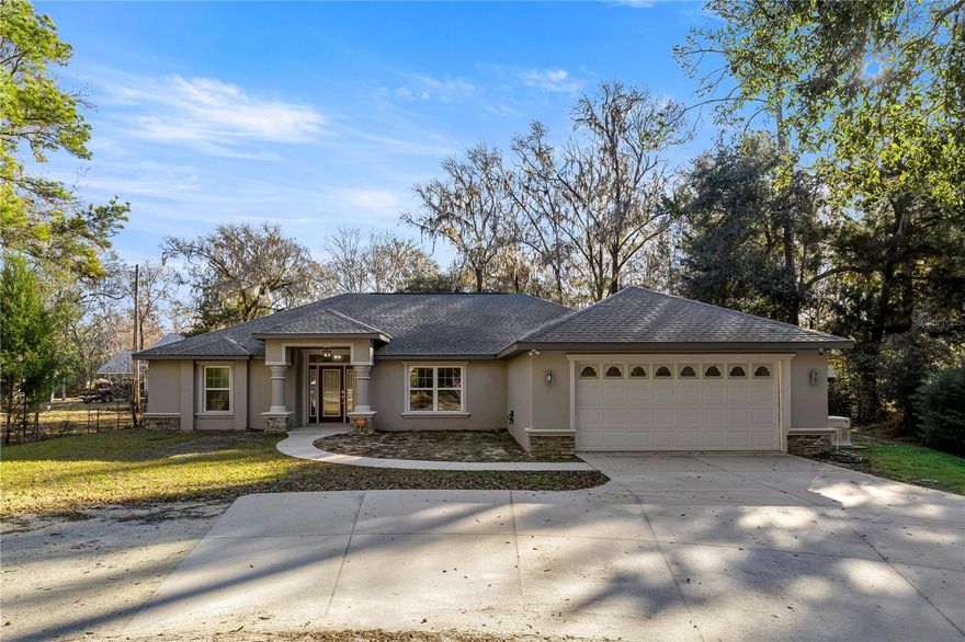 Welcome to luxury waterfront living on the infamous Rainbow River. This stunning concrete block 2023-built residence offers 105 feet of pristine river frontage, complete with a seawall & existing boathouse, creating the perfect setting for boating, kayaking, and enjoying Florida’s natural beauty. Situated on 2.18 acres outside of a flood zone, this thoughtfully designed split-bedroom home features soaring cathedral ceilings, luxury vinyl plank flooring, and abundant natural light throughout. The open-concept layout includes a separate dining area and an eat-in kitchen. The spacious primary suite boasts double vanities and a private retreat feel, while generously sized guest bedrooms share a full guest bath. Additional highlights include an inside laundry room, oversized two-car garage, and a massive 24x20 covered back porch—perfect for relaxing and taking in breathtaking river views. A rare opportunity to own newer construction on one of Florida’s most sought-after waterways. Schedule your private showing today.