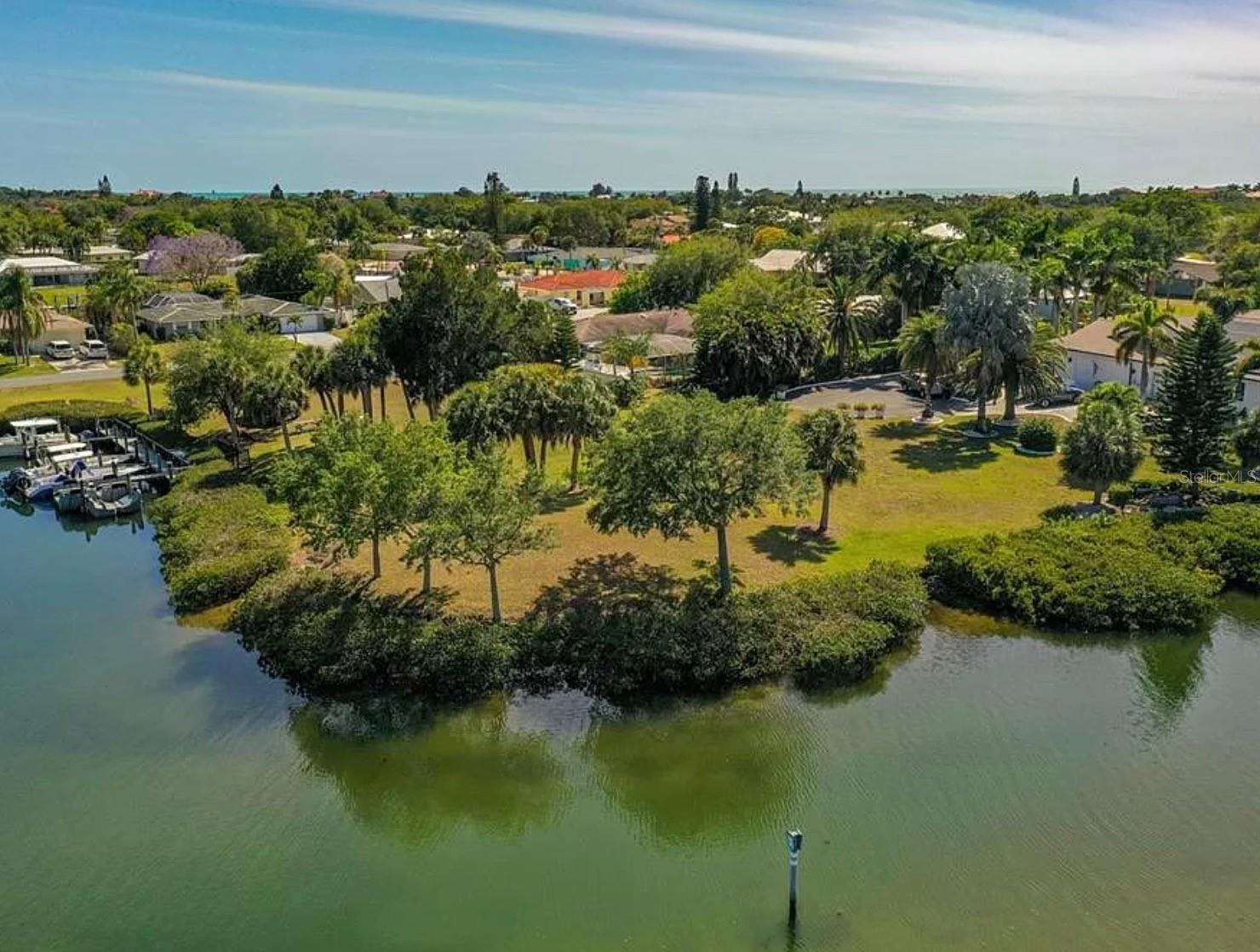 Under contract-accepting backup offers. Magnificent waterfront corner property West of Trail. At 0.66 acres, this flat lot is bordered by South Creek on two sides, and the deep salt water canal leads directly to the Intracoastal Waterway and Gulf of Mexico. The views are breathtaking, with uninhabited mangrove islands dotting the wide canal, waiting for you to launch your boat and head to a waterfront restaurant, a nearby beach, the Venice Jetty or Siesta Key. The property sits at the end of a private road This is an exceptional gem, rarely found this close to Siesta Key, Venice Beaches and outstanding restaurants and shopping. The property has been recently surveyed and platted, had an environmental survey/report completed and is ready to build. No HOA's, private road, room for a large dock.