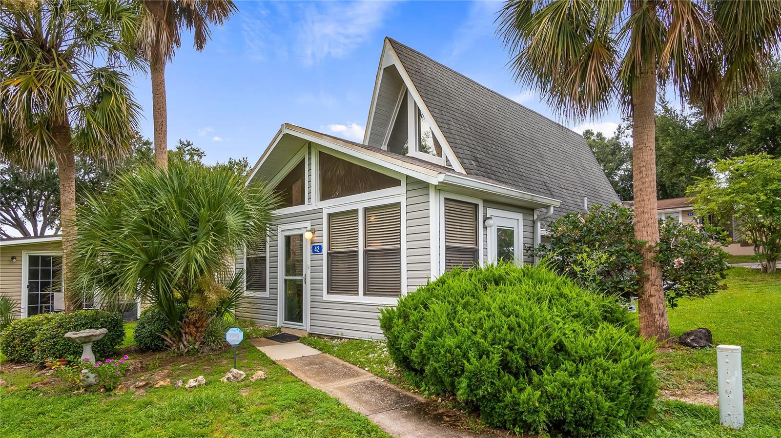 Central Florida UPDATED A-FRAME Vacation Village condo just hit the market! Who wouldn’t want to live the Florida Vacation Lifestyle every day? This 2-bedroom, 2-bathroom home features tastefully modern updates in the kitchen, including a newer refrigerator and a dedicated reverse osmosis faucet with triple filters for designated drinking water, and both bathrooms have been tastefully refreshed as well. Take a walk through now via this video link https://vimeo.com/1103883833 “Wood-look” tile floors flow seamlessly throughout the main level, making clean-up a breeze while creating an inviting, well-decorated space. A spiral staircase leads to the second bedroom loft with direct access to a private patio/balcony to soak in the fresh air and Florida sunshine. Additional features include a whole-home water filtration system, newer water heater, and full-size washer and dryer in the laundry/storage area off the Primary Suite. Vacation Village offers an incredible array of amenities covered by the monthly HOA fees, including an Olympic-size swimming pool, tennis, pickleball, shuffleboard and basketball courts, a car washing station, multiple playground areas, private beach access to Lake Louisa via the community lakefront lot, a private community boat ramp and dock, plus a fenced oversized parking area for RVs, vehicles, and boats for a small monthly fee. Live here full-time or part-time, rent long-term or short-term, or let the front office property managers handle bookings for you and simply collect the income. HOA fees also cover exterior maintenance such as roof and siding, lawn care, cable, WiFi, water, sewer, trash, and common area amenities, leaving you to pay only for electricity and property taxes. Just minutes to everything you need including groceries, shopping, medical care, entertainment, and dining, with Orlando International Airport, Universal Studios, and Walt Disney World® less than 30 minutes away, and world-famous beaches like Daytona Beach only about 90 minutes away. Unit is sold furnished. Come check out this amazing condo and experience everything Vacation Village has to offer!