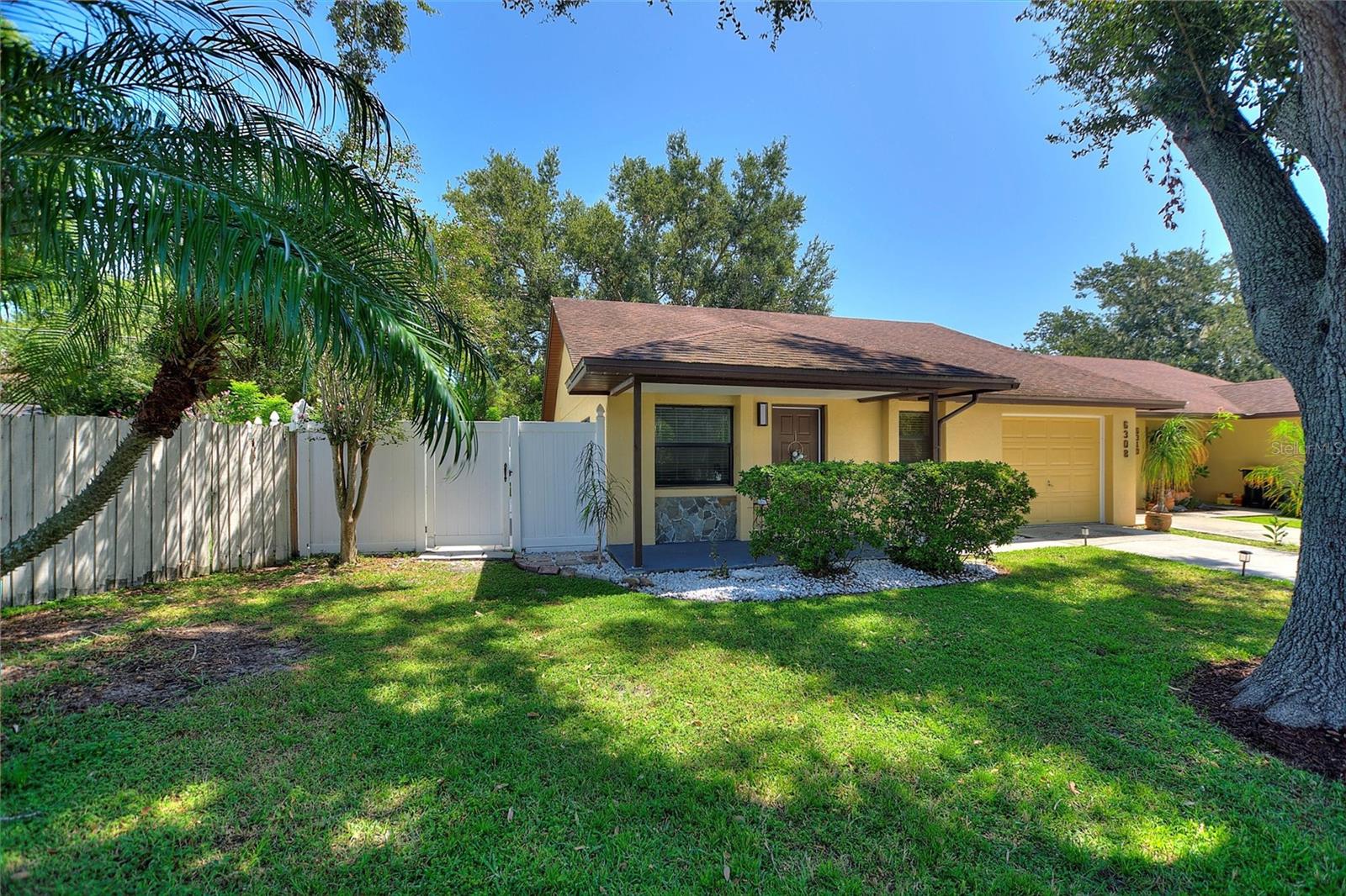 Perfectly situated on an OVERSIZED CUL-DE-SAC LOT, this outstanding 3 Bed, 2 Bath duplex is a rare find in Lakeland’s DESIRABLE CHRISTINA NEIGHBORHOOD – the best part, NO HOA!! Enjoy unbeatable convenience – just minutes from Publix, Wal-Mart, Sam’s Club, Lakeside Village Mall and a wide variety of other restaurants and shopping. Updated for peace of mind – NEW A/C 2024! Step into an exceptional FULLY FENCED BACK YARD, with a spacious lawn and beautiful oak trees providing shade and charm – this is a perfect place to host an outdoor gathering. Approaching the home, the curb appeal truly shines with fresh landscaping, a large picturesque oak tree, updated exterior paint, a cozy covered front porch, and a long driveway providing lots of guest parking. When you enter the home the living room welcomes you with vaulted ceilings and a light and airy feel, while a large sliding glass door leads to the back porch – perfect for INDOOR-OUTDOOR LIVING and entertaining. Adjacent to the living room is a flexible dining area with space for a coffee bar, leading into a BEAUTIFULLY UPDATED KITCHEN featuring granite countertops, a stylish tile backsplash, tons of counter and cabinet space, and modern appliances. The two guest bedrooms are generously sized and have been freshly updated with modern finishes and the guest bathroom features a large vanity, updated countertops, fixtures, and a clean, contemporary design. The private primary suite includes an en-suite bath with a tile stall shower, a walk-in closet, and direct access to a private back porch — your own quaint retreat. An oversized single-car garage provides room for both your vehicle and extra storage, plus washer and dryer hookups. Need even more storage? A large backyard shed is perfect for garden tools, outdoor gear, or holiday décor. This is true value in the desirable Christina community — don’t miss your opportunity. Schedule your private showing today!
