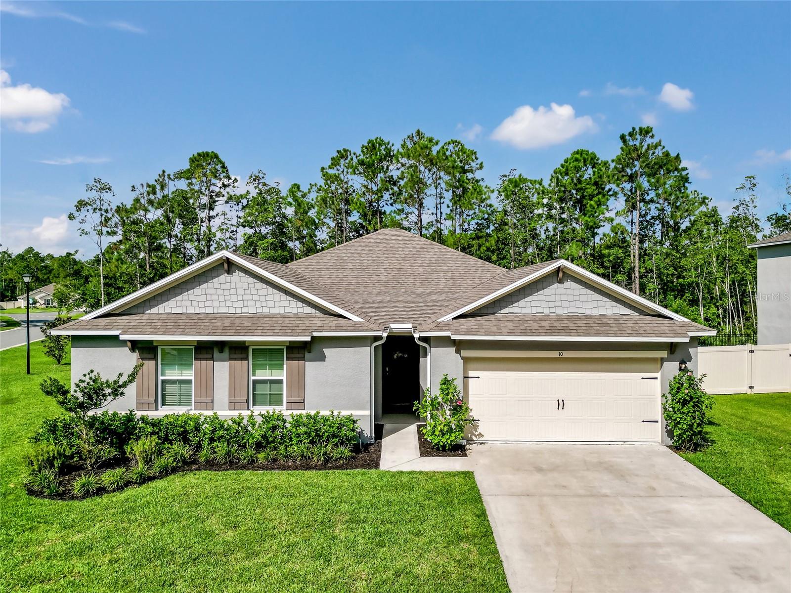 Welcome to your dream retreat in the serene Pineland subdivision of Ormond Beach! This stunning 2022 single-family home, nestled on a coveted corner lot spanning over a .29 acres, offers the perfect blend of modern living and natural tranquility. Backed by a lush conservation area, you’ll enjoy unparalleled privacy with no future neighbors behind you.
Step inside this stylish four-bedroom, two-bath residence, thoughtfully & stylishly designed with neutral decor to suit any taste. The open floor plan creates a seamless flow between the living spaces, making it perfect for entertaining or family gatherings. Spacious bedrooms and large walk-in closets provide ample storage and comfort, while beautiful tile floors throughout the main areas, complemented by cozy carpet in the bedrooms, add a touch of elegance.
Embrace the outdoors with inviting landscaping and the charm of your peaceful surroundings, where majestic oaks and towering pines create a picturesque backdrop. Enjoy leisurely strolls on the expansive sidewalks of this friendly community, or take a refreshing dip in the wonderful pool during hot summer days.
Plus, with a generator interlock kit installed, you can rest easy knowing your home is prepared for storm season. Conveniently located just minutes from I-95, the stunning East Coast beaches, and a variety of shopping options, this home offers easy access to all that Ormond Beach has to do.
This residence is not just a place to live; it’s a lifestyle filled with comfort, privacy, and natural beauty. Don’t miss your chance to make this oasis your own!