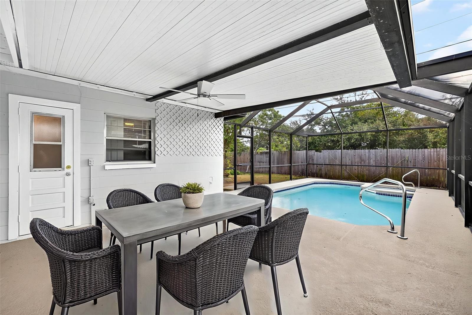 One or more photo(s) has been virtually staged. Completely Remodeled Move-In Ready POOL Home! Welcome to this stunning, updated 4-bedroom, 2-bath home in the heart of the Town N Country area of Tampa. Beautifully remodeled by licensed contractors, this home is ready for its new owners to enjoy. Recent updates include a 2025 HVAC system, water heater, kitchen, and bathroom renovations. The interior showcases luxury wood-look tile flooring throughout, complemented by elegant lighting fixtures.  The 2025 custom kitchen is a true showpiece and the heart of the home, featuring a large, stylish quartz center island perfect for gatherings, stainless steel appliances, and modern cabinetry, ideal for enjoying conversation while cooking and entertaining. The primary suite offers an ensuite bathroom with a walk-in shower and a convenient exterior pool entrance. The home also provides multi-generational living options with an additional living room and extra bedroom space for everyone to spread out and relax.  Step outside to enjoy the private covered patio and screened pool, ideal for entertaining or relaxing in your privacy-fenced backyard with room for pets or gardening. Bring your toys! The oversized driveway provides plenty of parking for multiple cars, an RV, or boat.  The current owner has been part of caring for this home for over 60 years! Seller notes that the 2024 storms were the only time the property has ever flooded, and all restoration work was completed by licensed contractors. >> Flood insurance is transferable, with the current policy at an affordable $3,149 per year (ask for details- we’re happy to share).<<  Conveniently located near hospitals, shopping, dining, and entertainment, and within walking distance to both public and privates schools.  This home is just 10 minutes from Tampa International Airport and about 25 minutes either east to downtown Tampa or west to world-class Gulf beaches. Combining modern elegance, comfort, and an unbeatable location, this property is truly move-in ready and waiting for its next owner to enjoy.