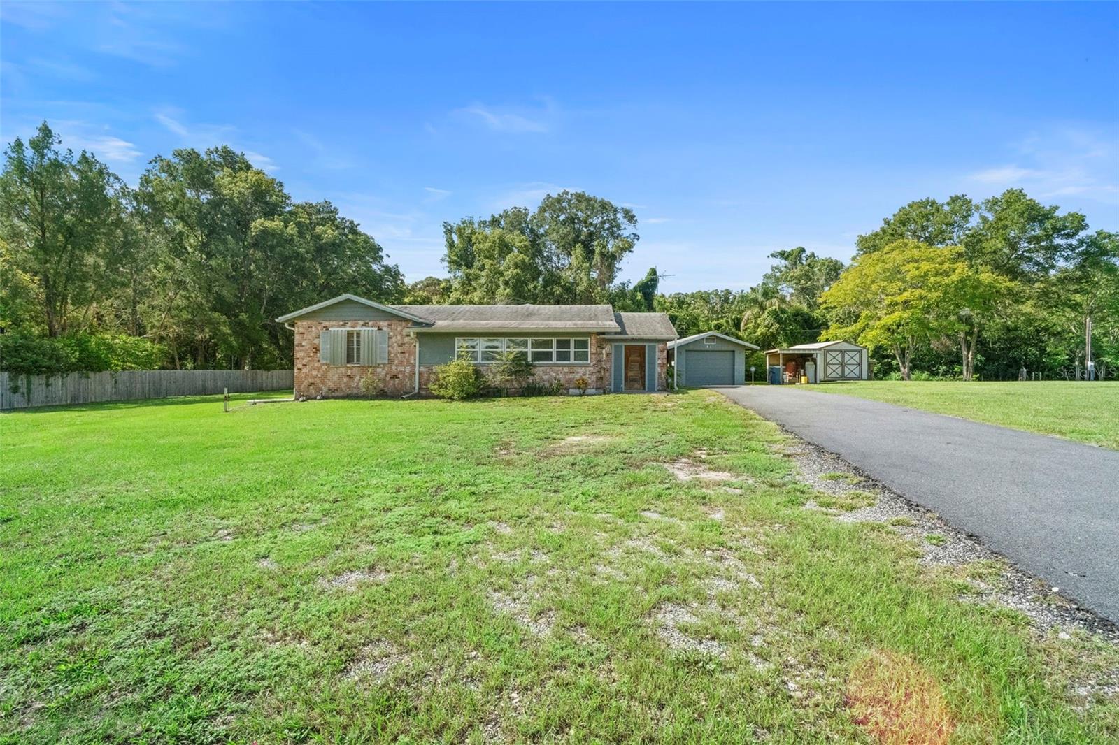 Welcome to 753 Glenwood Road — an exceptional 1.86-acre property in the heart of DeLand that offers space, versatility, and endless opportunities. With A-3 zoning, cleared land, and full fencing, this property is ideal for those looking for a homestead, small farm or garden, chickens, or simply room to spread out and enjoy the Florida lifestyle.
The main home features 2 bedrooms, 2 baths; and 1,430 sq. ft. of comfortable living space. Although it could use updates, the space is what matters! Just imagine a new, updated kitchen! There is also an enclosed porch off of the living room; need a 3rd bedroom? Finish this space off for that extra living space! Just steps away, the garage includes an attached studio apartment, perfect for guests, extended family, or rental income. An additional detached 1/1 structure is also on the property behind the main home. Again, these spaces need attention but with some sweat equity and time, this could be an amazing compound! Altogether, the property offers 2,778 sq. ft. under roof. The main house & garage roofs were fully replaced in 2019. The main house AC was replaced in 2022.
Bring your RV, toys, or equipment — there is a large carport behind the main house, as well as a power hookup for an RV and plenty of room for storage or future projects. The open, cleared acreage and full fencing make it ready for animals, gardens, or outdoor recreation. And don't forget the workshop! Ready for you an your projects - insulated & has power!!
This is more than just a home — it’s a rare opportunity to create your vision on a prime piece of land in sought-after DeLand. Don’t miss your chance to make 753 Glenwood Road your own!
