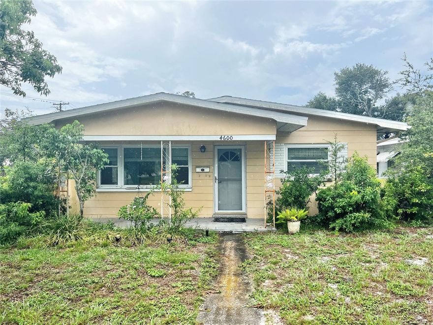 This beautiful, mid-century style 3/2 concrete-block home is in a great location - halfway between the beautiful BEACHES of St Pete and all the fun of Downtown St Pete!  A UNIQUE FEATURE of this home is that one of the bedrooms is a LARGE SUITE with a SECOND KITCHEN. This side of the house has its own entrance and could be used as a separate living space for a tenant, an older parent, an older child, the possibilities go on.  A larger main kitchen is on the other side of the home and features ample cabinet space, a lighted ceiling fan, ceramic floors, a dishwasher, refrigerator, and a flat top stove range.  The ELECTRIC and PLUMBING have been UPDATED in this home, and the TWO AC's and TWO hot water heaters are newer.  You'll love the SAVINGS to your electric bill that the DOUBLE-PANED WINDOWS will bring..... INSIDE laundry hookups..... TERRAZZO flooring in two of the bedrooms..... and WOOD PLANK in the third bedroom.  Both bathrooms have WALK-IN SHOWERS and safety grip bars.  The SKY-TUBES you see in the ceiling in some of the photos bring additional natural light during the daytime and moonlight at night.  Although there are some features you can personalize/update to make your own....this home is MOVE-IN READY!  There is NO HOA and NO CDD fees for this home, and it requires NO FLOOD INSURANCE!  NOTE: the roof is older and age is unknown. However it's in good condition, so the seller is offering $5000 in concessions toward the eventual new roof.  This home is priced to sell, so make your appointment now to visit!!!