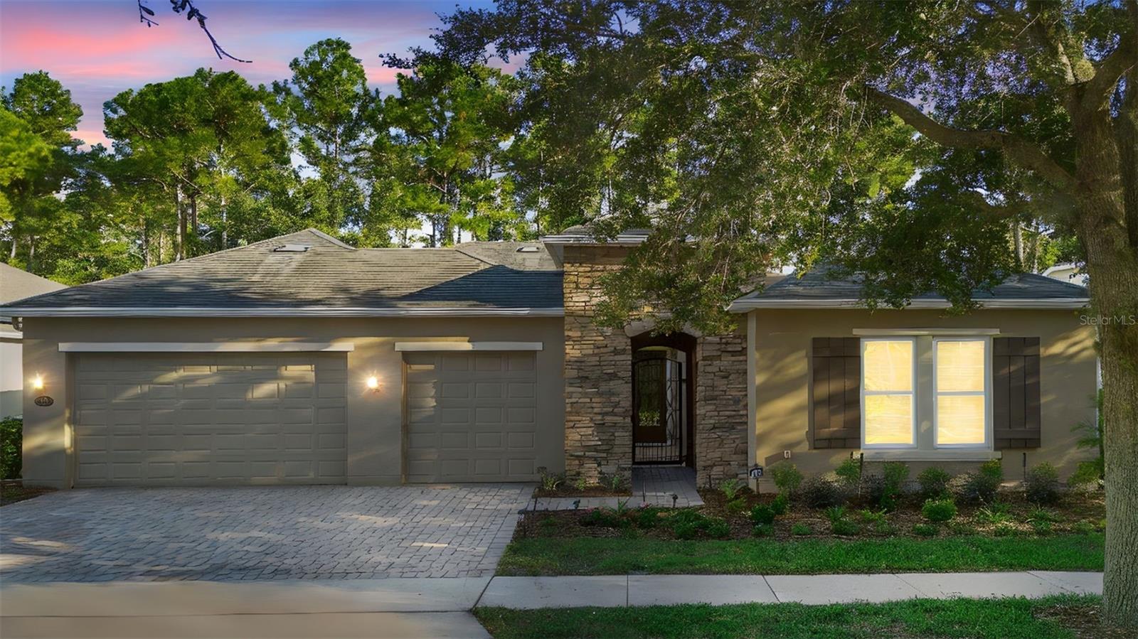 One or more photo(s) has been virtually staged. Welcome to this stately home in one of Central Florida’s most sought-after 55+ gated communities. This stunning 2-bedroom, 2.5-bath residence is packed with upgrades and thoughtful details that make it truly better than new. From the moment you arrive, you will be greeted by lush landscaping and a charming Italian Villa-style courtyard—a beautiful prelude to what awaits inside. Step through the front door and experience a spacious open-concept floor plan with luxurious touches throughout. The gourmet kitchen is a chef’s dream, featuring granite countertops, a built-in oven, microwave, refrigerator, kitchen island, and butler’s pantry. With loads of cabinetry, meal prep and entertaining are a breeze. Just off the kitchen, the family room flows seamlessly into the formal living room, where a gas fireplace sets the mood for cozy Florida evenings. Hosting guests? The expansive formal dining room offers plenty of space for gatherings and special occasions. This home is adorned with plantation shutters on every window, ceiling fans, and decorative light fixtures that elevate each space with style and comfort. Need a quiet space to work or reflect? The study offers a serene setting complete with a custom mural of the Mediterranean Sea. Your primary en-suite is a personal sanctuary, featuring his-and-hers sinks, a luxurious garden tub, an oversized walk-in shower, and a show-stopping walk-in closet with room for everything. The second bedroom boasts a grand closet with built-ins. The additional powder room adds extra convenience for guests and showcases a beautiful mirror and soft lighting.
The private screened porch overlooks a dense conservation area, offering peaceful views and privacy. Step outside to enjoy a beautifully paved patio—ideal for morning coffee or evening cocktails. If you have been searching for a home that combines elegance, function, and peace of mind, Close to schools, shopping, I4, and beautiful downtown DeLand! 1128 Heron Point Way delivers in every way. Welcome home!