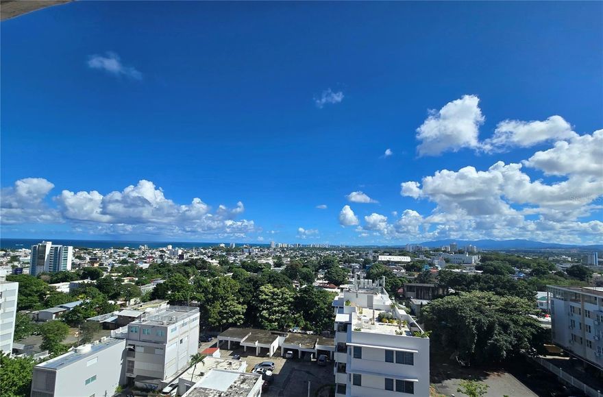 Exclusive opportunity to rent a residence in one of San Juan’s most iconic architectural buildings, located at the highest point of the city. From every area of the apartment, enjoy sweeping 180-degree panoramic views encompassing the Atlantic Ocean coastline, El Yunque National Rainforest, and the skyline of the metropolitan financial district.
This corner unit faces east, allowing for abundant natural light and excellent cross-ventilation. It offers 1,722 square feet of living space, configured with three bedrooms and two full bathrooms, providing both spaciousness and comfort.
The condominium features a heated swimming pool—an extremely rare amenity in today’s market—as well as a children’s playground. Its prime location provides immediate access to major roadways and is within walking distance to restaurants, retail services, and Santurce Park, and just five blocks from one of the city’s best beaches.
The building is equipped with a newly installed generator offering 100% power redundancy.