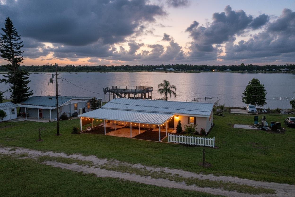Enjoy stunning sunrises and sunsets from this beautifully renovated 2-bedroom, 2-bathroom split plan block home with a durable metal roof! Situated directly on the shores of Lake Buffum, a 1,268-acre lake known for some of the best bass, catfish, and bluegill fishing in the area…and now you can call it your backyard. This home has been thoughtfully updated with modern features and timeless charm. Recent improvements include new CPVC plumbing, and a full rewire with 200-amp service. The new electric hot water heater, new kitchen appliances, and butcher block countertops bring efficiency and style to the heart of the home. The interior and exterior have been freshly painted, and new luxury vinyl plank flooring has been installed in the primary bedroom, bath, and Florida room. The spacious Florida room offers wall-to-wall windows with breathtaking lake views. Both bedrooms, as well as the Florida room, overlook the water. The primary suite is a private retreat, featuring a sitting area with serene lake views, new sliding glass doors to the backyard and lake, and a fully remodeled ensuite bath with a tiled shower, tongue-and-groove ceiling, and a stylish barn door. Additional highlights include an inside laundry room, a refreshed guest bathroom, and new landscaping. Outside, a boat dock remains in place and may be eligible for permitting to rebuild to your specifications. For added convenience, a new public boat ramp on Doc Lindsey Road is less than 1/4 mile away, making it easy to launch your boat and enjoy all that Lake Buffum has to offer. Don’t miss this opportunity to own a move-in-ready lakefront home with modern upgrades and unbeatable views!