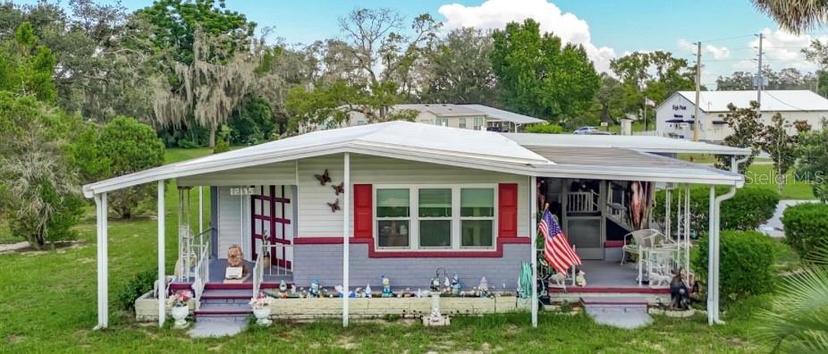 Welcome to High Point—a vibrant 55+ community in Hernando County where affordability meets resort-style living. This inviting two-bedroom, two-bath double-wide manufactured home sits proudly on an oversized corner lot of more than 10,000 sq. ft., complete with a vinyl-fenced backyard and multiple patio areas—up to four in total—perfect for both privacy and entertaining. Best of all, you own the land, making this true real property. Inside, you’ll find a bright and open floor plan designed for easy living. The kitchen, featuring hardwood cabinetry, double oven, refrigerator, microwave, and dishwasher, flows naturally into the dining and living areas, creating a welcoming space for gatherings. Luxury vinyl flooring runs throughout the home, and fresh paint, newer floors, and brand-new windows add to its move-in-ready appeal. A unique feature you’ll love—the AC vents are thoughtfully placed in the ceilings, not the floors, providing a clean, modern touch. Additional conveniences include an indoor laundry room with washer, dryer, sink, and storage, plus a one-car garage with extra space for storage and a large driveway that can accommodate four or more vehicles. High Point itself is a golf-friendly community where residents enjoy an active and social lifestyle. The HOA not only allows RV parking but also offers outstanding amenities for just $43 a month. You’ll have access to a clubhouse filled with activities, clubs, and events, as well as a library, swimming pool, tennis courts, pickleball, shuffleboard, bocce ball, and, of course, the 18-hole golf course. Pride of ownership is evident throughout this home—it has been lovingly cared for and is truly move-in ready. For added convenience, a golf cart and riding lawnmower are also available for purchase. If you’re ready to retire, relax, and stay connected, this home may be exactly what you’ve been searching for. Don’t wait—call me today to schedule your private showing!
