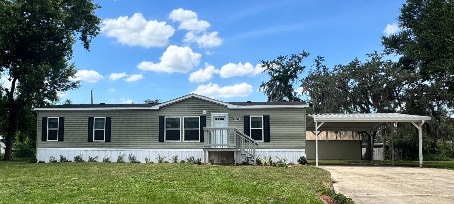 Welcome to your new home in sunny Central Florida! This beautiful brand-new 2025 mobile home is more than just a house—it’s a place where memories are made, laughter is shared, and life unfolds in comfort and style. Step inside and feel right at home with a bright, open layout that’s perfect for gatherings big or small. The heart of the home is the spacious kitchen with a large island—perfect for morning pancakes, holiday baking, or late-night chats. The thoughtful split-bedroom design offers privacy for everyone, with three bedrooms, each featuring walk-in closets. The primary suite is your private retreat with a huge closet and a beautifully appointed en-suite bath, the perfect place to unwind after a long day. Outside, enjoy the patio out back for barbecues, sunsets, or weekend get-togethers. There’s a carport to keep your vehicle cool, and two sheds for hobbies, storage, ideal for a workshop, studio, or guest retreat. —both with electricity, and one finished and one with water. As a resident, you’ll have access to a private neighborhood boat ramp on beautiful Lake Fox so bring your boat, kayaks, jet skis, and water toys. Whether you're out fishing at sunrise or tubing on a sunny afternoon, lake life is right at your fingertips.Tucked away on a peaceful lot near Legoland, with shopping, restaurants, and everything you need just minutes away and no HOA telling you what to do, this home offers the freedom and comfort you've been searching for. Whether you're starting fresh or settling down, this is a place where you can truly live, grow, and make lasting memories. Welcome home.