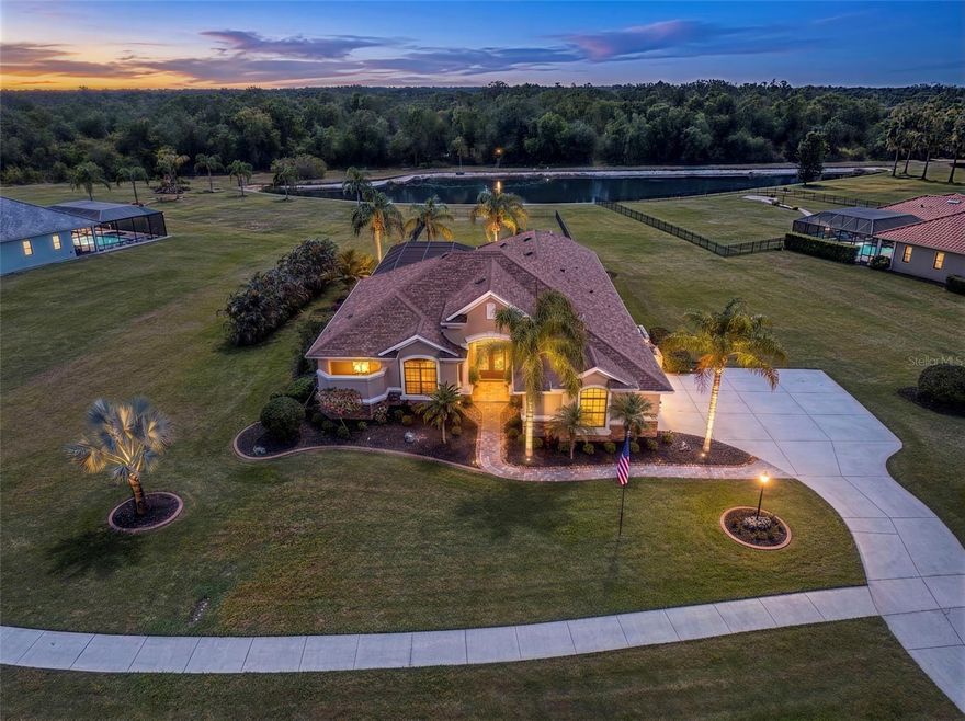 One or more photo(s) has been virtually staged. Assumable VA Mortgage available with a 2.25 % Interest rate. Twin Rivers is a community where luxury meets nature as it spans over 1,800 acres of forest, wetlands and pastures along the Manatee River. This Arthur Rutenberg-built home is well positioned on a desirable 1.3-acre lot, offering tranquil water and conservation views that provide ultimate privacy. The community also allows for two-story detached structures, offering the flexibility to store an RV and other recreational vehicles. This STUNNING 4-bedroom, 3-bathroom home, complete with an office (with closet), boasts impressive exterior features such as stacked stone, columns framing the covered entry, and a spacious 3-car side-entry garage. Elegance and comfort blend seamlessly as you enter through the double doors into a welcoming foyer and formal living area, where your eye is immediately drawn to a stunning view of the outdoor living space beyond. High ceilings, crown molding, and diagonal ceramic tile flooring flow throughout the main living spaces and wet areas, enhancing the home’s open and inviting feel. The dining room features plantation shutters, a newer chandelier, and a tray ceiling accented with crown molding. The GOURMET style kitchen has newly installed Quartz countertops with waterfall and matching full height backsplash, stainless steel appliances including a newer LG ThinQ Smart Refrigerator with Wi-Fi Capability and cooktop (2024), and dishwasher, garbage disposal and faucet (2022-2023). The family room is designed for both everyday living and entertaining, and features fully collapsible sliders that extend your living space into the expansive outdoor area, creating a seamless indoor-outdoor flow and opening to your own private OASIS! The saltwater pool and spa are complemented by two covered lanais and ample space for lounging and entertaining. The landscaping has been thoughtfully designed to enhance PRIVACY while creating a vibrant, tropical setting. Back inside, the three-way split floor plan offers a private primary retreat featuring a tray ceiling accented with crown molding, designated reading lights, and a remote-controlled blind for the sliders. The en-suite is LUXURIOUS with newly installed Quartz countertops and a zero-entry dual-use walk-through shower with private courtyard view enhanced by customizable lighting with a variety of color options. There are two walk-in closets that make for ease of storage. Two of the secondary bedrooms are located behind a pocket door along with a second full bathroom.  The fourth bedroom and game room are located at the rear of the home behind a pocket door, along with a third full bath that also serves as a pool bath with convenient outdoor access.  No CDD, No Flood Zone, New Roof (2025), newer pool pump and heater (2023), HVAC Systems 2021, and more. See the feature sheet. Residents enjoy access to the gated River House on the Manatee River, featuring a boat ramp, dock, canoe and kayak launch and storage, fishing pier, pavilion, playground, and scenic hiking trails. Conveniently located near Fort Hamer Park and boat ramp, Manatee River, Florida Railroad Museum, River Wilderness Golf Course, Rye Nature Preserve, Ellenton Outlets, and Lake Manatee State Park. Easy access to Lakewood Ranch, Bradenton, Sarasota, and Tampa, with world-class beaches just 30 miles away.