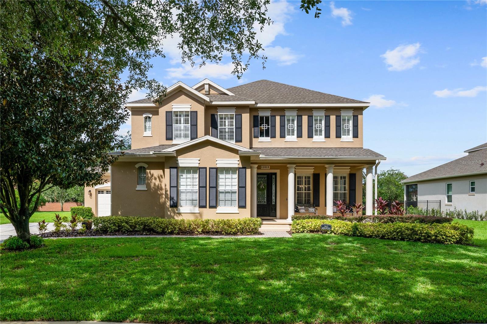 Welcome to this beautifully maintained, original-owner home nestled within the highly sought after, guard-gated community of Keene’s Pointe. Ideally situated in the charming Village of Camden, this property sits on an oversized 0.35-acre lot, with beautiful walking paths and lush community green spaces nearby. From the moment you arrive, you’ll be captivated by the meticulously landscaped grounds, inviting front porch, and elegant glass entryway. Step inside a grand vaulted foyer bathed in natural light and anchored by rich, distressed wood flooring that flows seamlessly throughout the main living areas. Inside you will find the living room/sitting area adjoining an elegant dining room adorned with tray ceilings, crown molding, graceful pillars, and curved archways. A private home office featuring stylish glass French doors offers a quiet retreat just off the dining room. Continue through the spacious halls to the beautifully remodeled gourmet kitchen, with top-of-the-line stainless steel Bosch appliances, 36” Wolf Pro range cook top, Zephyr wine cooler, expansive quartz countertops, a generous center island, and a cozy breakfast nook with views of the lanai. The kitchen opens effortlessly into the warm and inviting family room, complete with 2-story vaulted ceiling, a wood-burning fireplace, and two sets of French doors that lead to the expansive screened-in, pavered lanai with convenient air-conditioned half bath. The spacious first floor primary suite offers its own entryway from the family room and showcases a tray ceiling, double doored primary retreat with THREE closets, oversized soaking tub and frameless glass shower. A secondary junior office/study nook is conveniently located near the laundry room, offering extra space for remote work or organization. Make your way upstairs to find a spacious open loft, three additional bedrooms and two full baths. One of the guest bedrooms features an en-suite bath and a charming window seating area—ideal for guests or multigenerational living. The oversized, fully fenced backyard offers a tranquil escape, complete with a brick privacy wall and a cozy firepit area—perfect for relaxing evenings outdoors. The extended driveway and unique configuration of separate one and two car garages provide ample space for parking and storage, both garages feature updated LED lighting and epoxy flooring. Enjoy the peaceful lifestyle that the Village of Camden and this exceptional home have to offer. As a resident of Keene’s Pointe, you’ll also have the option to join The Golden Bear Club, featuring tennis, dining, and the renown Jack Nicklaus Signature Golf Course. NEW Roof in 2018, Wood floors 2021, Both ACS New 2021, Garage epoxy floors 2025, Exterior Paint 2021. See feature sheet for more details.