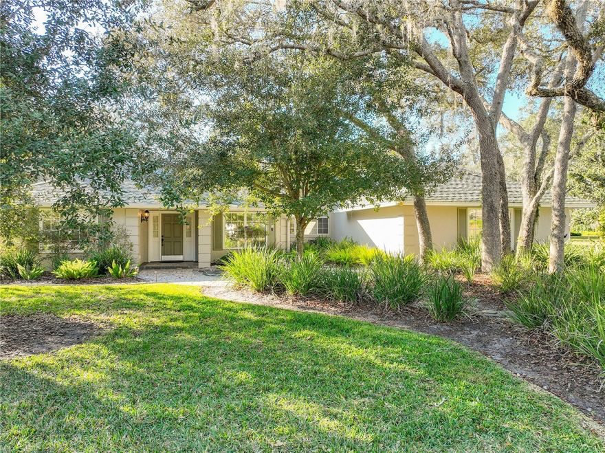 This meticulously updated and exceptionally well-maintained custom home by renowned builder Buck Adkins sits on a generous 0.4-acre lot in the highly sought-after Tuscawilla community- one of the most prestigious and established neighborhoods in Seminole County. Approach this beautiful residence along slate & paved walkways illuminated by elegant lighting, winding through a mature canopy of trees that create a serene, welcoming entrance. The newly sodded backyard is a true oasis, featuring a bounty of fruit trees- fully enclosed by an 8ft privacy fence. A massive double gate opens to an extended parking pad, easily accommodating an RV or boat. Extensive pavers extend from the front driveway & sidewalk, wrapping around to the backyard and leading to the stunning screened pool enveloped in lush tropical foliage. The pool area includes a spacious covered porch with Chattahoochee-finished concrete, skylights, an industrial-sized fan, sink & cabinets- perfect for year-round outdoor living. Abundant windows throughout the home- especially in the kitchen, living room, & primary bedroom- frame lush views of this private paradise. Step inside this versatile, light-filled custom floorplan boasting wood plank flooring, crown molding, chair rails, plantation shutters on tinted windows, staggered neutral tile, and high knock-down ceilings for an open, elegant feel. The updated kitchen is a chef's dream, featuring rich wood cabinets, granite countertops, a central island with cooktop, stainless steel appliances including a double oven & wine refrigerator, plus a convenient eat-in area. The expansive living room impresses with soaring ceilings & a cozy wood-burning fireplace, ideal for gatherings. The spacious primary suite offers direct pool access, dual walk-in closets with custom California closet built-ins, and a luxurious en-suite bathroom complete with double-sink vanity,  enormous marble-tiled walk-in shower with frameless glass, and private access to a paved, fenced outdoor atrium. On the opposite wing, discover incredible flexibility: an upstairs bonus room or additional bedroom, a bedroom with walk-in closet and pool access, another bedroom featuring a built-in Murphy bed, a cozy study/den, and French doors opening to a huge multi-purpose room with walk-in closets- perfect as a family room, hobby space, in-law quarters, or easily dividable into 2 more bedrooms with a simple wall addition. The updated guest bathroom includes dual sinks, granite counters, & direct pool access. Additional highlights include an inside laundry room with cabinets, sink, humidity exhaust fan, and newer washer/dryer that convey; a 3-car garage with updated doors; a separate storage closet for yard tools; and recent upgrades such as roof (2021), AC (2022), hot water heater (2021), pool pump (2024), new insulation (2023), Int & Ext paint (2023) and so much more! Also a dedicated panel/plugin for the generator that conveys.  Zoned for some of Seminole County's top-rated schools- this prime location offers easy access to bike trails, major highways, shopping, dining, and the community's renowned amenities, including parks, trails, playgrounds, splash pads, & the nearby Tuscawilla Country Club (with golf, tennis, pool, & dining- membership optional).This turnkey gem combines timeless custom craftsmanship, thoughtful updates, resort-style outdoor living, and unbeatable Seminole County convenience- a rare opportunity in one of Central Florida's most desirable communities!
