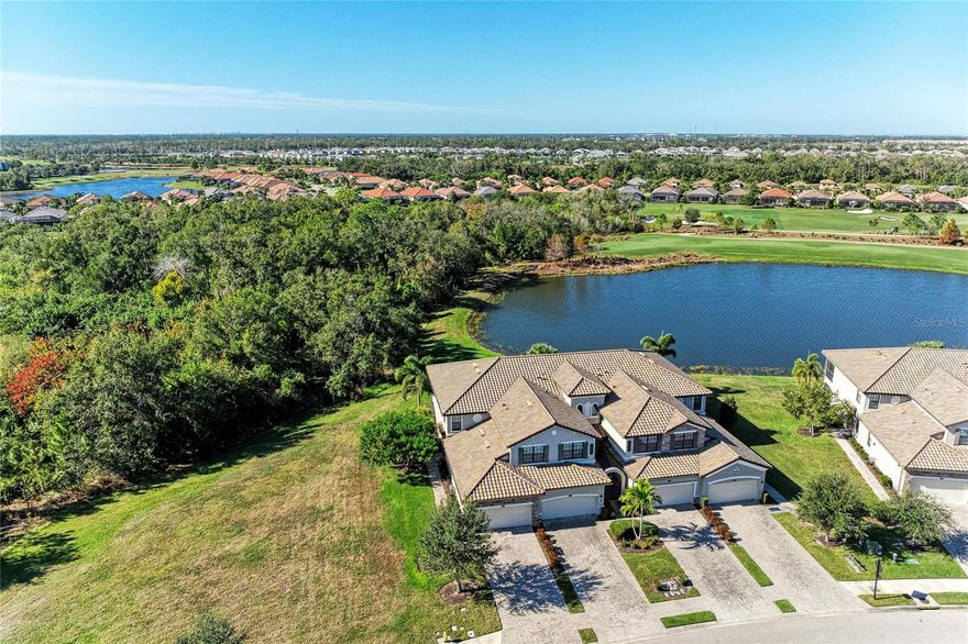 In the gated community of Lakewood National Golf Club in Lakewood Ranch, this first-floor corner coach home offers the privacy and convenience of a residence with amenities of a premier golf lifestyle. Spanning 1,786 square feet, the home features three bedrooms and two baths, including a spacious primary suite with a walk-in shower, double sink vanity and built-out walk-in closet. The open-concept layout centers around a large kitchen with granite countertops, stainless steel appliances, custom lighting and an island ideal for entertaining. The great room, complete with stunning feature wall and a linear fireplace, flows seamlessly onto a screened patio that showcases tranquil lake views and vibrant wildlife. Custom new ceiling fans and tile and new LVT flooring throughout the residence enhance comfort and style. This pet-friendly home includes a two-car garage and a generously sized grassy area, offering an ideal setting for outdoor enjoyment. Positioned near the community pool and surrounded by natural beauty, the residence provides access to top-tier amenities and championship golf lifestyle Lakewood National is known for.  Owners in Lakewood National Golf Club enjoy deeded golf membership, giving them the ability to play 36 holes of championship golf year-round. The Commander course at Lakewood National Golf Club was named No. 1 Golfers’ Choice and No. 1 Top Course in Florida by Golf Advisor. Lakewood National Golf Club offers gated, maintenance-free living with extraordinary resort-style amenities that include 36 holes of Arnold Palmer-designed golf courses, a zero-entry heated pool with cascading waterfalls and lap lanes, poolside tiki bar and café, fitness center with group exercise classes, on-site full-service spa, eight lighted Har-Tru tennis courts, bocce, pickleball, several satellite pools and a stunning 28,000-square-foot clubhouse which offers fine and casual dining, an expansive bar and lounge, men’s and ladies lounges and locker rooms, conference and meeting space, a full-time lifestyle director who keeps residents social life fun and active with trivia night, karaoke night, live concerts on the green, extravagant holiday parties, wine-tasting dinners and more. Lakewood National Golf Club hosts the annual Korn Ferry Tour’s LECOM Suncoast Classic. Easy to show and move-in ready!