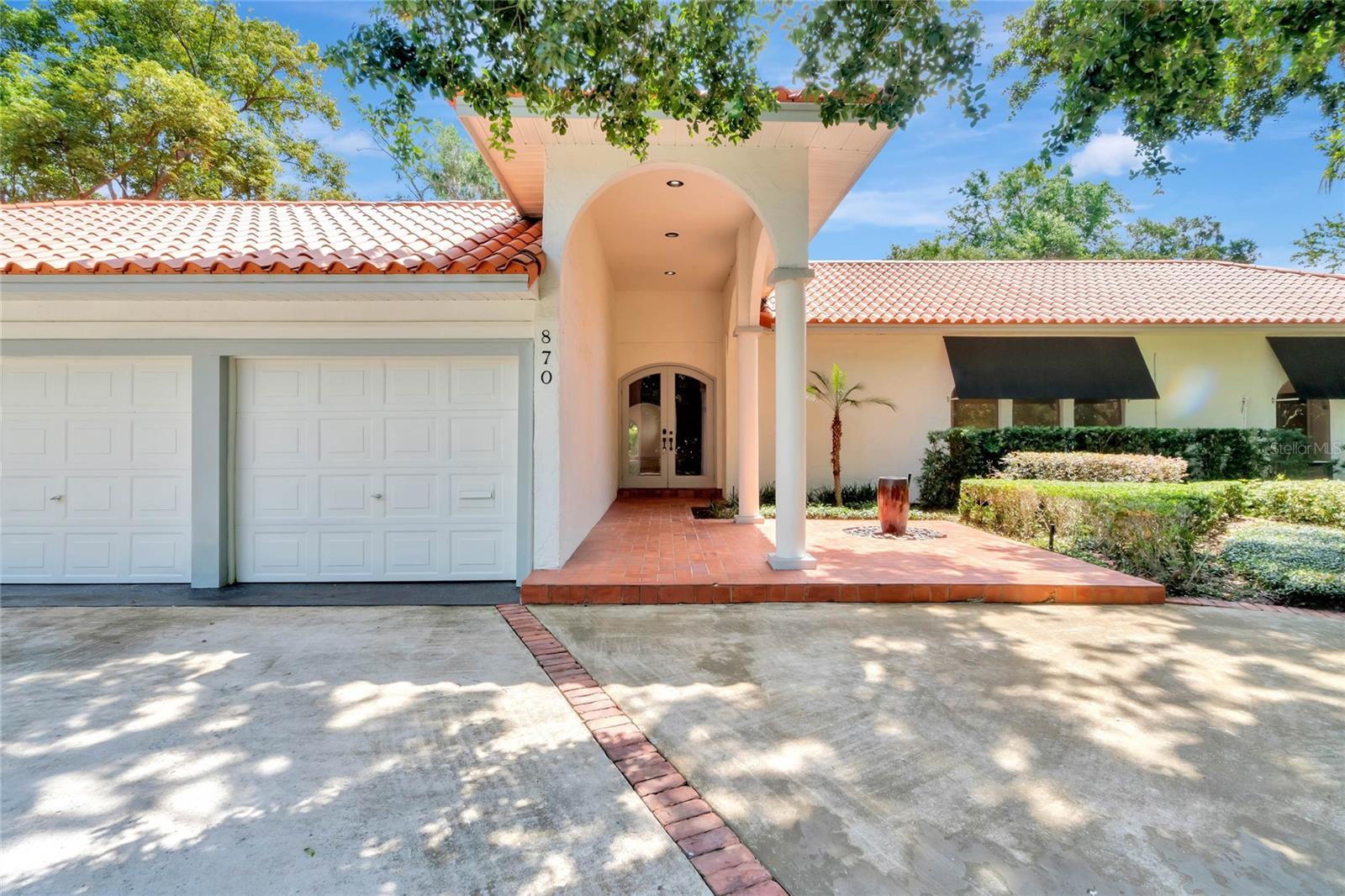 NEW AND IMPROVED PRICE: Located in the heart of “The Golden Triangle” of Winter Park, this 0.43 acre property is approximately 125 feet wide by 150 feet deep. Discretely hidden behind a wall of podocarpus, this exclusive Georgia Avenue opportunity is only a few short blocks from the retail and restaurants located on Park. Live in the lovely, one-story 2,709 SF Santa Barbara style pool home currently sitting on the property as it is, add on and renovate it to make it your own or tear it down to build the custom home of your dreams. The current home includes a deep covered entry to greet your guests. Beyond the front door is an ample foyer and powder bath. Visible from the foyer are several old-world-style brick walls with gracious arches. Directly through the foyer’s arched opening you will find the entertaining areas — kitchen, dining and family rooms. The dining area is complete with a built-in bar. Updated countertops in the kitchen, lighting and neutral paint allow these flexible spaces to be well received by guests and owners alike. A touch of warmth is added by the masonry fireplace. Multiple sets of french doors and large scale windows allow for an abundance of natural light and a direct view of the enormous backyard. The mature landscaping, pool and broad brick patio area are ideal for entertaining or private enjoyment. Large scale windows also line the galley hallway to the right of the foyer where you will find the master suite featuring a renovated bathroom updated with a soaking tub, designer tile, lighting fixtures and vanities. Continuing down the hall are the two remaining bedrooms, a shared full bathroom and a bonus area. Incredible new house plans designed by the collaborative team of Cynde Norris and Jodie Warrick Konold of Scout & Company Lifestyle + Design are offered with the sale. The Kingston House plans reflect a 6,010 SF estate in a Modern Tudor style with five bedrooms, plus an office and detached Casita as well as an accompanying six full and one half bathrooms.