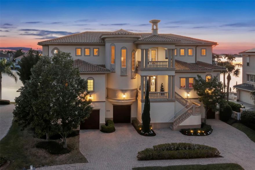 Introducing a Remarkable Waterfront Residence at an Unbeatable New Price. Discover the allure of this exceptional 5-bedroom, 5 1/2-bath waterfront masterpiece, meticulously crafted by Windstar Custom Homes and now presented at an amazing new price. Every aspect of this home reflects unparalleled artistry and unwavering attention to detail, tailored to meet the exacting standards of its discerning owner. Step inside to experience a seamless blend of top-quality materials and meticulous craftsmanship at every turn. This thoughtfully designed floor plan ensures that each family member enjoys the luxury of an en-suite bath, walk-in closets, and captivating water views. Spanning 5,545 heated square feet and a grand total of 10,785 square feet, this Spanish Mediterranean-style abode exudes timeless elegance and sophistication. Noteworthy stone and millwork, including 9 1/4-inch baseboards, 7 1/4-inch crown molding, and solid wood doors, create an atmosphere of refined luxury throughout the home. Situated on an extra-large lot with 107 feet of waterfront and a new seawall, this property offers ample space for a yacht and water toys, making it a truly unique opportunity. As you enter through the double mahogany front doors, you'll be greeted by breathtaking westward views in the formal living room, featuring cathedral ceilings, a cast stone gas fireplace, and floor-to-ceiling windows that frame the spectacular water vistas. The formal living and dining areas offer a front-row seat to unforgettable sunsets over Boca Ciega Bay, seamlessly blending stone floors with exquisite cherry hardwood. There is an office/study, adorned with mahogany cabinetry, a natural gas fireplace, and stunning coffered ceiling details, provides an ideal space for the family's CEO. The great room, incorporating a homework station, serves as the heart of entertainment. The culinary haven of the kitchen boasts custom cabinetry, a walk-in pantry, and top-of-the-line appliances, including a gas Wolf range, creating the perfect setting for hosting friends and family. The primary suite offers a luxurious sanctuary, complete with a cherry wood vestibule area, morning kitchen, and a dedicated workout/yoga room. The exquisite primary bath features a double-sided shower and a Jacuzzi tub, while a spacious covered deck off the master bedroom invites you to savor morning coffee while taking in magnificent views.

Outdoor living is equally impressive, with a fabulous pool, spa, and ample entertaining space on multiple covered expansive decks on all levels. Car enthusiasts will appreciate the incredible (3190 SQFT) garage, offering space for 5-plus vehicles and substantial storage. An elevator effortlessly connects all stories from the garage area, ensuring seamless access to every corner of this architectural masterpiece.

This exclusive club stands as the only gated, golf course, and truly waterfront community in the area. As an added bonus, the fortunate buyer of this home is offered the advantage of skipping the waitlist to join the highly sought-after Pasadena Yacht & Country Club. Don't miss this amazing buy and opportunity to make this exceptional waterfront residence your own.