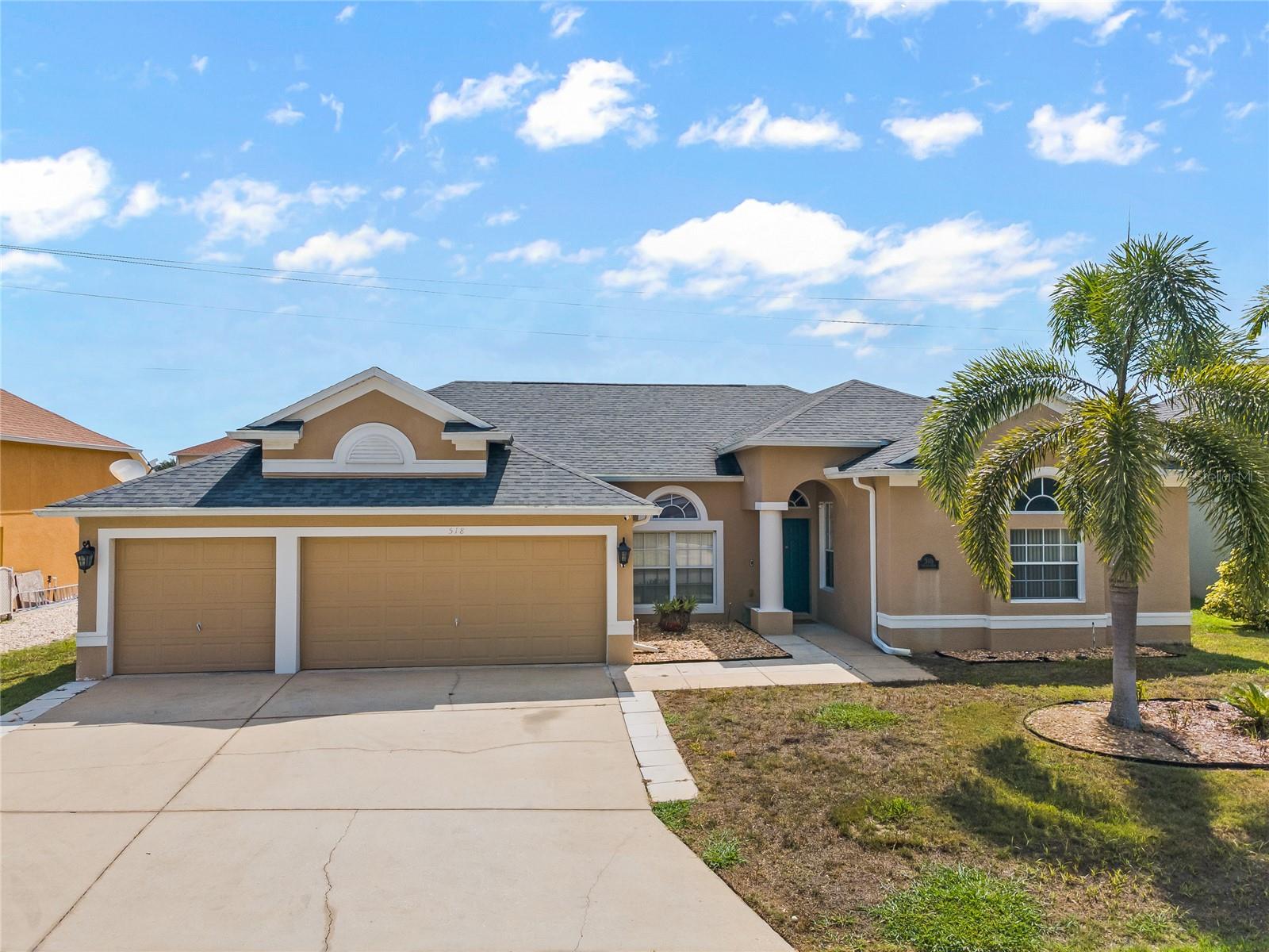 Tucked beneath swaying palm trees and surrounded by lush tropical landscaping, this stunning 4 bedroom, 3 bathroom pool home is located in the highly sought-after gated, low HOA community of Grand Reserve. From the moment you arrive, the curb appeal is undeniable, highlighted by an oversized three-car garage that offers ample parking and versatile storage for water toys, golf carts, or even a small boat. Step inside to an airy, light-filled interior where arched windows, natural light, and easy-to-maintain tile floors create an inviting atmosphere. Just off the foyer, a formal sitting area and dining room offers elegant spaces for hosting, with large sliding glass doors drawing your eye to the serene lanai and pool area. A bright and sunny office space sits nearby, perfect for remote work, creative pursuits or utilized as a 5th bedroom. At the heart of the home, the chef’s kitchen impresses with warm wooden cabinetry, stainless steel appliances, a tile backsplash, stylish pendant lighting, and a large center island for casual dining and conversation. A charming corner dinette provides the ideal spot for morning meals, while a custom dry bar with extra cabinet space and a wine fridge adds a touch of sophistication. The kitchen opens directly to a cozy living room featuring beautiful built-ins, an electric fireplace, and wide sliding glass doors that frame the backyard view. Just off the kitchen, the renovated laundry room offers thoughtful upgrades including a built-in sink, generous counter space, and storage. The split floor plan ensures privacy, with the primary suite serving as a true retreat. This spacious sanctuary includes dual vanities, a soaking tub, a separate glass shower, a walk-in closet, and direct access to the lanai and pool. Three additional bedrooms provide space for guests or hobbies, with the fourth bedroom offering its own en-suite bathroom and direct access to the pool, making it a prime guest suite or in-law setup. Step into your private backyard retreat, where a screened-in pool and expansive patio offers the perfect setting to relax, entertain, or simply savor the peaceful ambiance as the sun rises. The sparkling pool invites refreshing morning swims and leisurely evening laps, while the surrounding patio is ideal for hosting weekend barbecues and gatherings with friends. Encircled by a fully fenced yard, this outdoor haven is enhanced by mature lychee, mango, avocado, and lemon trees, providing natural shade and fresh, homegrown fruit all year long. Centrally located near top-rated schools, major commuter routes, theme parks, shopping, and dining, this meticulously maintained home offers true luxury, and convenience. With nothing left to do but move in, this is Florida living at its best. Schedule your showing today before this exceptional opportunity slips away.