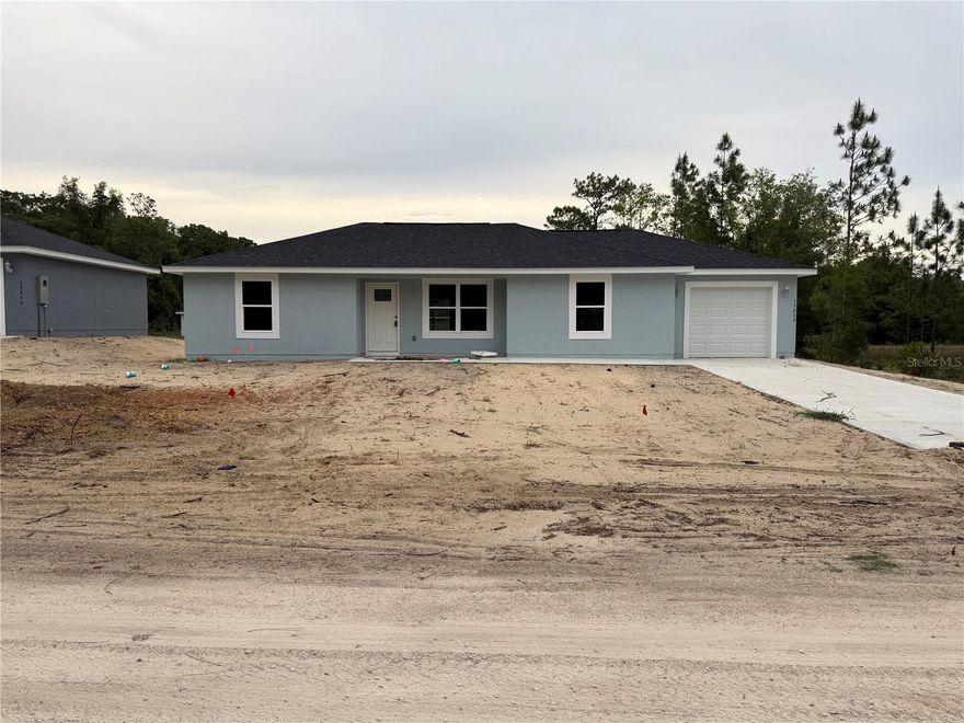 Under Construction. Step into this spacious stucco home offering an affordable opportunity with a well-designed split floor plan. The home features a modern kitchen with granite countertops, upgraded cabinetry, and a full stainless steel appliance package including range, microwave, dishwasher, and refrigerator. Tile flooring runs throughout, complemented by ceiling fans and thoughtful finishes. Enjoy the beautiful lot with fresh sod and a peaceful setting. Conveniently located near Rainbow River and the World Equestrian Center, this property provides easy access to a wide range of outdoor activities and events in Marion County. Homestead or Investment great pick!