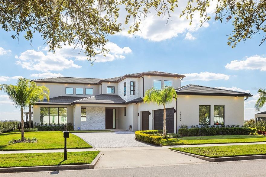 Welcome to 14544 Ave of the Rushes - A Masterpiece of Waterfront Luxury in Winter Garden’s Premier Community! Being sold Turn-Key and fully furnished!

Indulge in the pinnacle of luxury living with this breathtaking lakefront estate, perfectly positioned on the pristine shores of Lake Hancock within the coveted Signature Lakes community. Encompassing 1.18 acres of prime waterfront property, this architectural masterpiece offers an unparalleled blend of elegance, modern sophistication, and exceptional craftsmanship.

Spanning over an impressive 5000SqFt of refined living space (6,544 total square feet), this five-bedroom, five-and-a-half-bathroom residence is a testament to contemporary opulence. Designed by Davila Homes, the Lexington Floorplan Luxury Collection home features soaring ceilings, floor-to-ceiling windows, and an open-concept design that seamlessly integrates indoor and outdoor living.

The gourmet chef’s kitchen is a vision of culinary excellence, boasting top-of-the-line appliances, custom cabinetry, and an expansive island, ideal for both intimate gatherings and grand entertaining. The sumptuous primary suite is a private sanctuary, offering panoramic lake views, a spa-inspired en suite, and a spacious walk-in closet. Each of the additional four en-suite bedrooms exudes comfort and sophistication, ensuring a lavish experience for residents and guests alike.

Step outside to discover an exclusive waterfront oasis, complete with a private dock and direct access to the lake, perfect for boating and water sports enthusiasts. The resort-style pool and expansive outdoor lounge areas provide the ultimate retreat, where you can bask in the serenity of mesmerizing sunsets over the water. And as the evening sets in, enjoy the enchanting spectacle of Disney fireworks from your own backyard, a nightly display of magic that makes this estate truly one of a kind.

Designed for discerning buyers seeking the finest in luxury living, this estate offers an unrivaled blend of tranquility, prestige, and architectural brilliance. With its premier location, exceptional design, and breathtaking waterfront vistas, this estate redefines lakefront elegance in Winter Garden’s most sought-after community. The 3 car garage has a title flooring, and its perfect for car lovers! 

Experience uncompromising luxury—schedule a private viewing today.