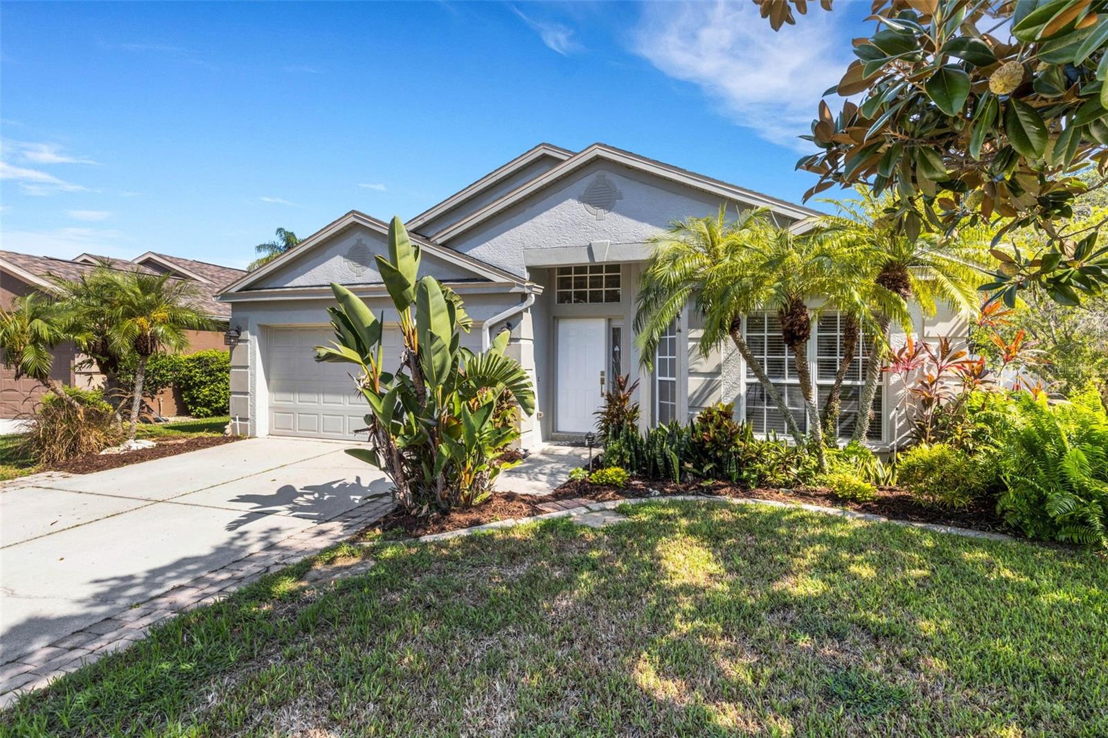 Experience Florida living at its finest in this beautifully maintained pool home located in the sought-after Sabal Harbour community! With nearly 2,000 sq. ft. of thoughtfully designed living space, this 3-bedroom, 2-bathroom residence offers the perfect blend of comfort, style, and functionality—ideal for families, professionals, or anyone looking to enjoy a relaxed, resort-style lifestyle. From the moment you step inside, you’ll appreciate the spacious open layout featuring tile floors throughout, fresh interior paint, and flexible living spaces including a den and an additional bonus room—perfect for a home office, playroom, or second living area. The large, functional kitchen is truly the heart of the home, complete with a center island with bar seating, ample cabinetry, and generous counter space—ideal for both everyday living and entertaining. The private primary suite serves as a tranquil retreat, featuring a walk-in closet, dual vanities, garden soaking tub, and a separate walk-in shower. Two additional bedrooms are located on the opposite side of the home for added privacy. Step outside into your own private oasis, where a sparkling heated pool and spa await inside a screened lanai designed for both relaxation and entertainment. The lanai features a covered area perfect for outdoor dining, plus plenty of deck space for sun loungers or conversation seating—all with partial lake views and lush landscaping creating a serene backdrop. Whether you're hosting guests or enjoying a peaceful evening at home, this outdoor space offers true Florida living at its best. Additional features include a 2-car garage, a new roof (2021), and new A/C system (2019), ensuring long-term peace of mind. As part of the vibrant Sabal Harbour community, you’ll have access to a wealth of amenities including a resort-style pool, tennis and pickleball courts, basketball courts, and a new, shaded tropical-themed playground. With low HOA fees and no CDD, this home offers exceptional value in a prime location just minutes from beaches, shopping, dining, and more. This is more than just a house—it's the Florida lifestyle you've been waiting for.