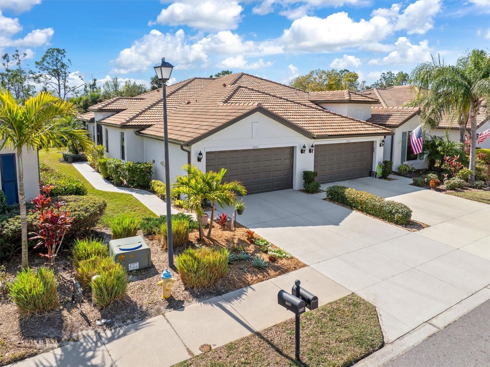 QUICK MOVE IN - Don't wait to join this awesome community and all the activities it has to offer! Welcome Home - this beautifully maintained 2-bedroom, 2-bathroom, 2 car villa is nestled in the highly sought-after, gated 55+ Del Webb community of Cypress Falls at The Woodlands. Bright and airy, the open floor plan is designed to maximize natural light, while the screened front entry entices the breezes to flow through in the cooler months. This unit boasts a chef friendly kitchen featuring black stainless steel appliances, elegant wood cabinetry with crown molding, granite countertops, a built-in pantry, and a spacious breakfast bar—perfect for entertaining. Retreat to the expansive owner’s suite, where tranquil preserve views create serene ambiance. The suite also offers a spa-like en-suite bath with a walk-in shower and dual sink vanity. A private guest bedroom and 2nd bathroom at the front of the home provides comfort and seclusion for your guests. This villa is designed with both style and functionality in mind, featuring, ceramic tile flooring, crown molding in the common areas, plush carpeted bedrooms, and elegant plantation shutters. The rear sliding glass doors open to an extended screened paver lanai where you can relax and soak in the lush green natural landscaping and scenic water view, while shaded by the retractable large span awning. The Cypress Falls Community Center offers an array of amenities, including: A full-time activities director ensuring year-round events and social gatherings Two heated pools (one with a relaxing lazy river/resistance circuit)whirlpool tub, as well as a state of the art fitness center, library, cafe, social hall with kitchen and more. Those desiring a different challenge can catch a game of pickleball, tennis, bocce ball or horseshoes. Also, a community garden, fenced dog park and various social clubs provides wide range of choices for residents and pets to enjoy. Rest easy knowing this home is not in a flood zone and is equipped with accordion, and storm panel shutters to protect the front, while easy to operate remote control shutters in the back make securing for a storm or trip away quick and easy. With a newer roof(2023), and low-maintenance living, this move-in-ready home offers both security and peace of mind. Centrally located in North Port with convenient access to I-75, US 41, beautiful Gulf beaches, shopping, dining, hospitals, and airports, this villa is the perfect place to call home.