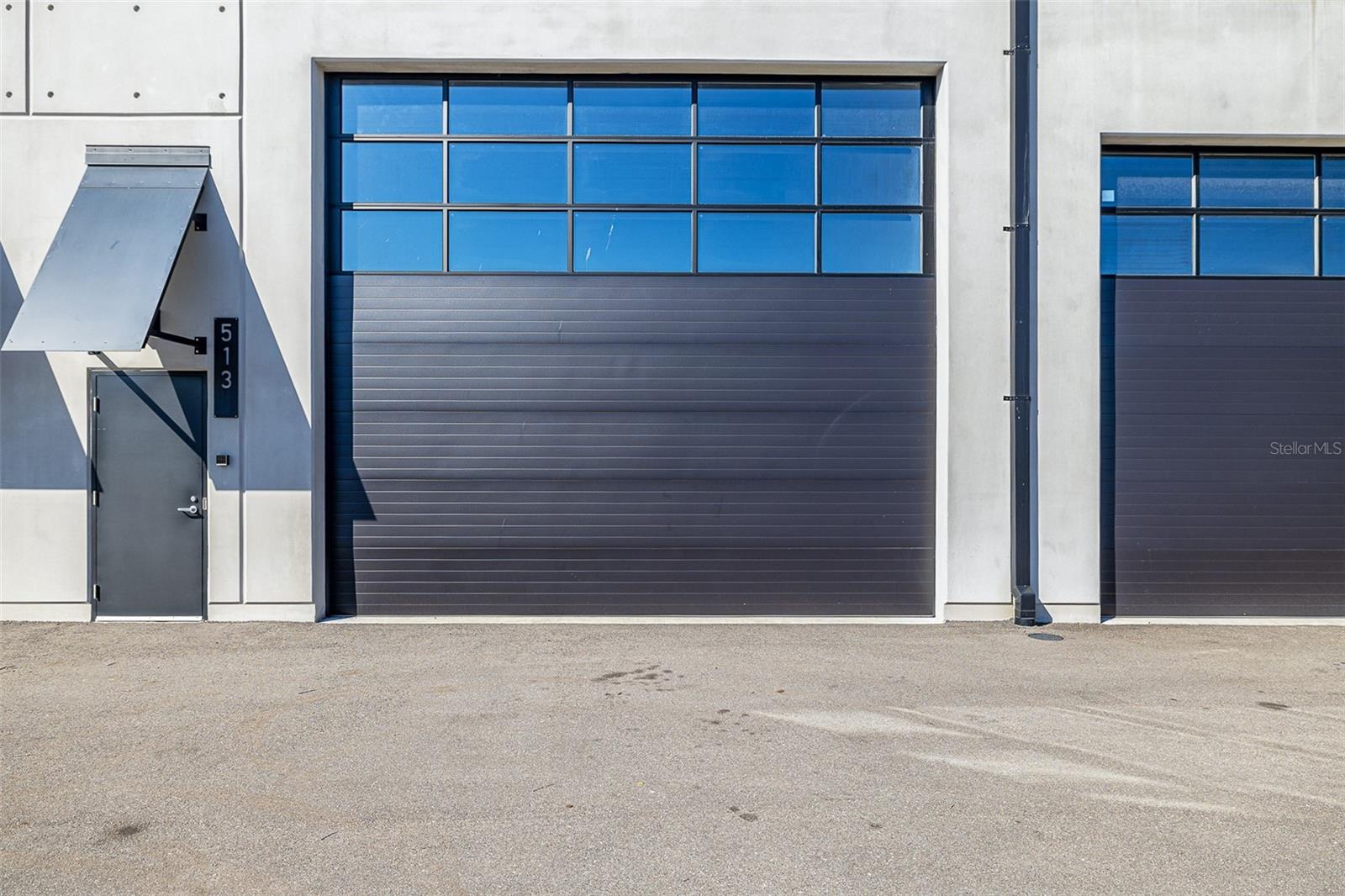 A Private Garage Like No Other, in a Motorsports Playground. The hum of high-performance engines, the scent of burning rubber, and the unmistakable thrill of speed—this is what life at The Motor Enclave is all about. Settled within 200 acres dedicated to the ultimate driving experience, this is more than just a place to store cars; it’s where automotive passion comes to life.
The largest unit currently available is perched above the heart of the action, this private huge 29x59 with 28 ft tall ceilings, 1,736-square-foot garage is more than a space—it’s a front-row seat to the adrenaline-fueled world of motorsports. Take in the sights and sounds of the Performance Driving Circuit, a world-class 1.72-mile track crafted by Formula 1’s most renowned designer, Hermann Tilke. The garage itself is a blank slate, offering towering 28-foot ceilings and the potential to build out a second level, doubling the square footage to create the ultimate workshop, lounge, or office space. With your garage steps away from the pool and club house area, you can relax or entertain using all of the clubs amenities. Or step out on your private balcony overlooking the off road track.
Designed with both function and flexibility in mind, this space is ready to accommodate more than seven vehicles, with a six-inch reinforced concrete slab built to support vehicle lifts or future expansions. It comes pre-plumbed for water and sewer, allowing for the addition of a private bathroom or kitchenette, while three-phase power, an individual HVAC unit, a fire sprinkler system, and an insulated overhead door ensure that every detail meets the highest standards.
But ownership here is about more than just the garage—it’s about the experience. With membership options at the exclusive Motorsport Club, the track is at your disposal, along with 100 acres of off-road terrain designed to push the limits of capability. A two-acre Vehicle Dynamics Pad provides the perfect setting for high-speed maneuvering, precision driving, and even laser-timed autocross challenges. When the engines cool, the 37,000-square-foot event center becomes the hub for networking, social events, and private gatherings, creating a community where enthusiasts, collectors, and industry leaders connect.
Perfectly positioned at the crossroads of Interstates 75 and 4, The Motor Enclave is minutes from downtown Tampa and a quick drive from Tampa International Airport, making it a seamless addition to any car collector’s lifestyle. Whether it becomes a high-tech workshop, a collector’s dream garage, or a trackside escape, this is a rare opportunity to own a piece of the ultimate motorsports destination.